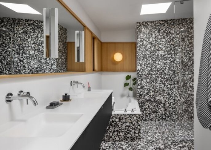 Bathroom with a marble countertop and terrazzo floor-min