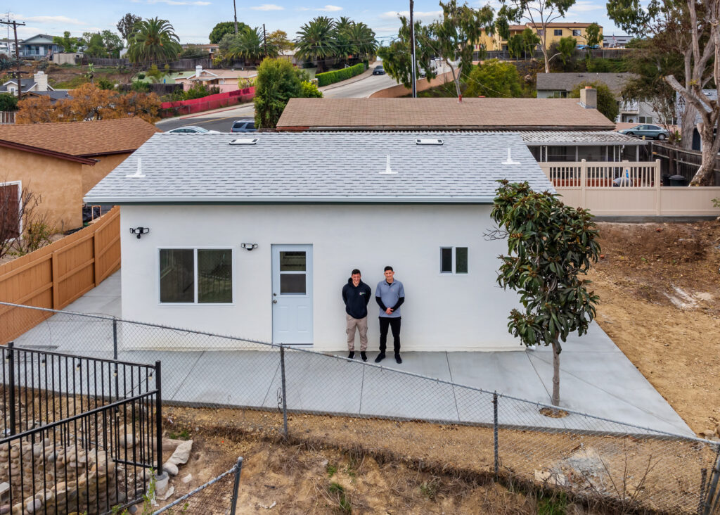 A modern San Diego residential lot featuring a primary single-family home alongside four distinct accessory dwelling units (ADUs), showcasing multi-unit stacking layout.