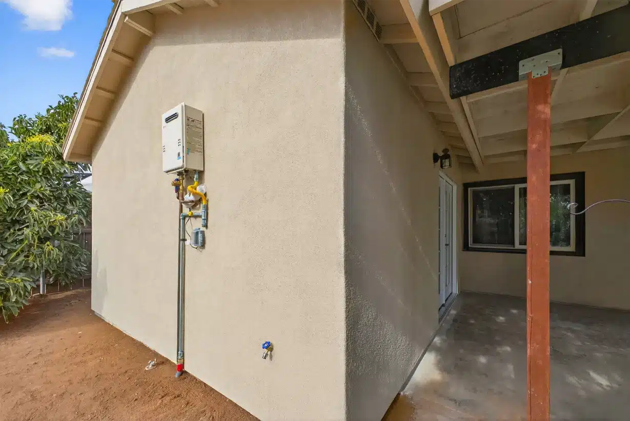 Completed exterior elevation in stucco alongside the new addition