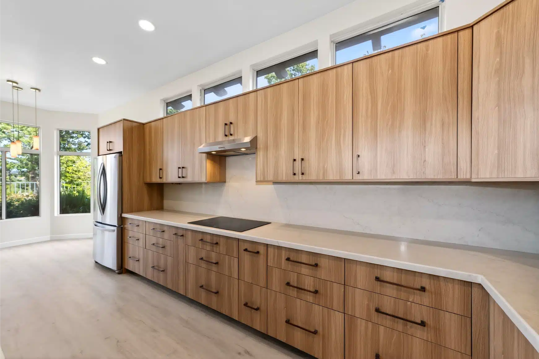 New kitchen run in rift oak with quartz counters and black tapware