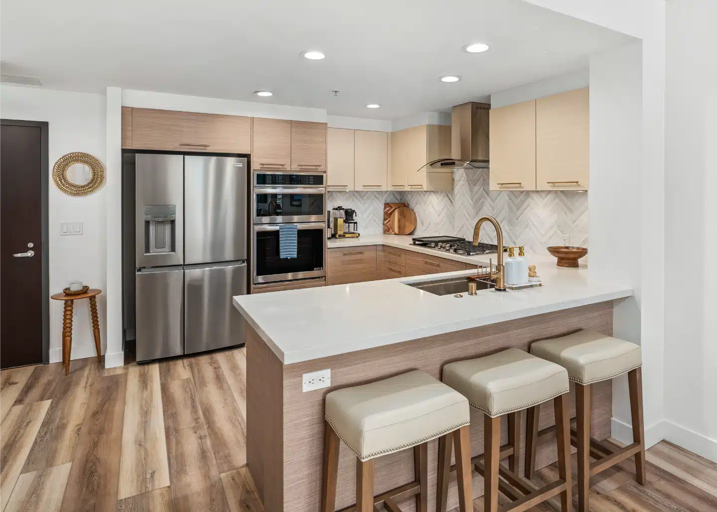 Kitchen with stainless wall ovens and a tall cabinet run in the Little Italy condo