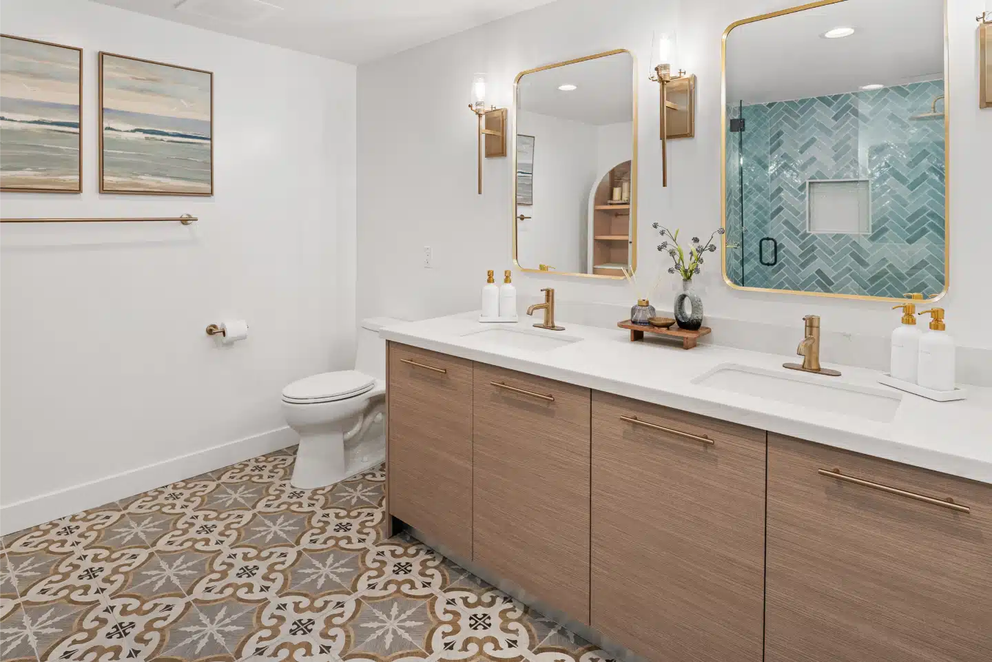Second bathroom with a floating oak double vanity, patterned floor tile and brass fixtures