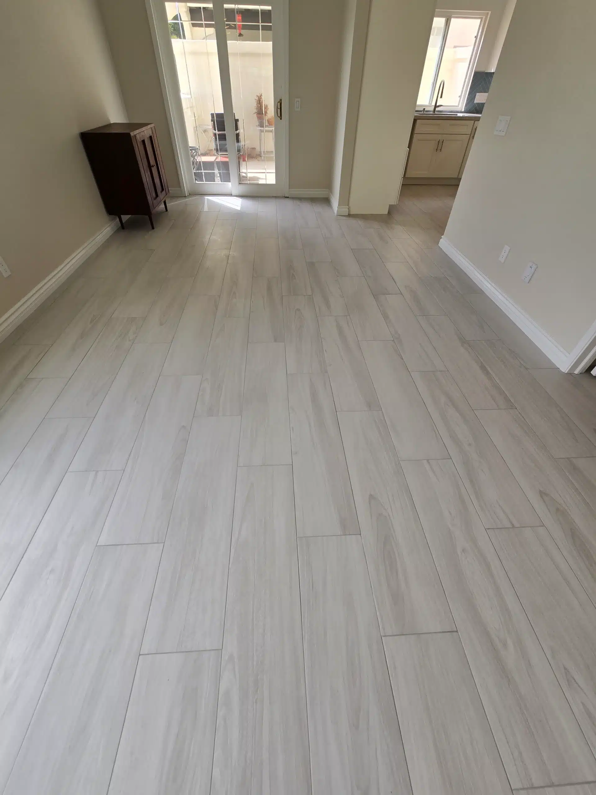 Hallway looking back toward the remodelled kitchen, with continuous plank flooring