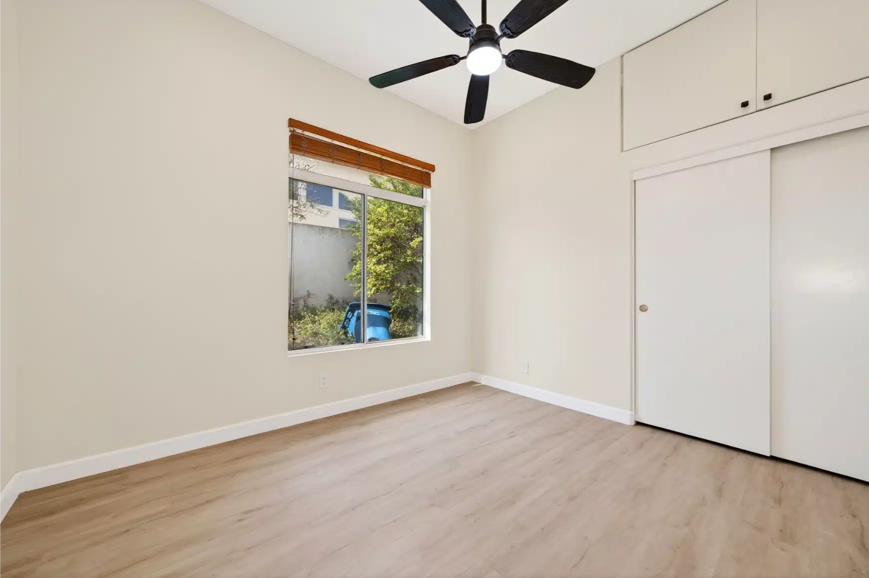 Bedroom with built-in storage and a ceiling fan