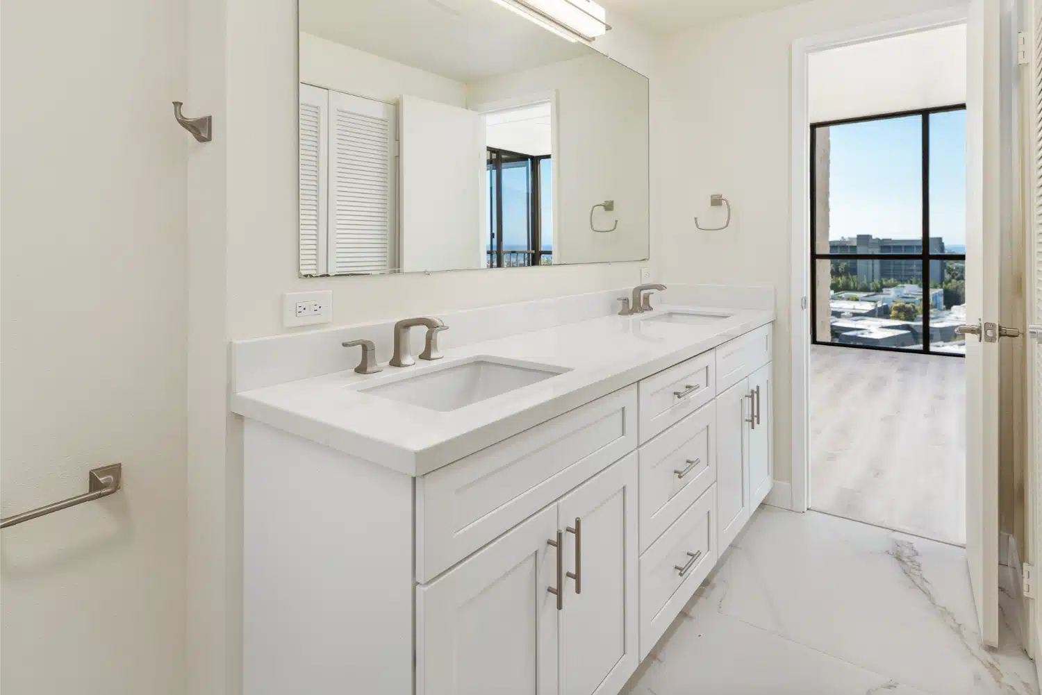 Second bathroom vanity with natural light from the adjoining room