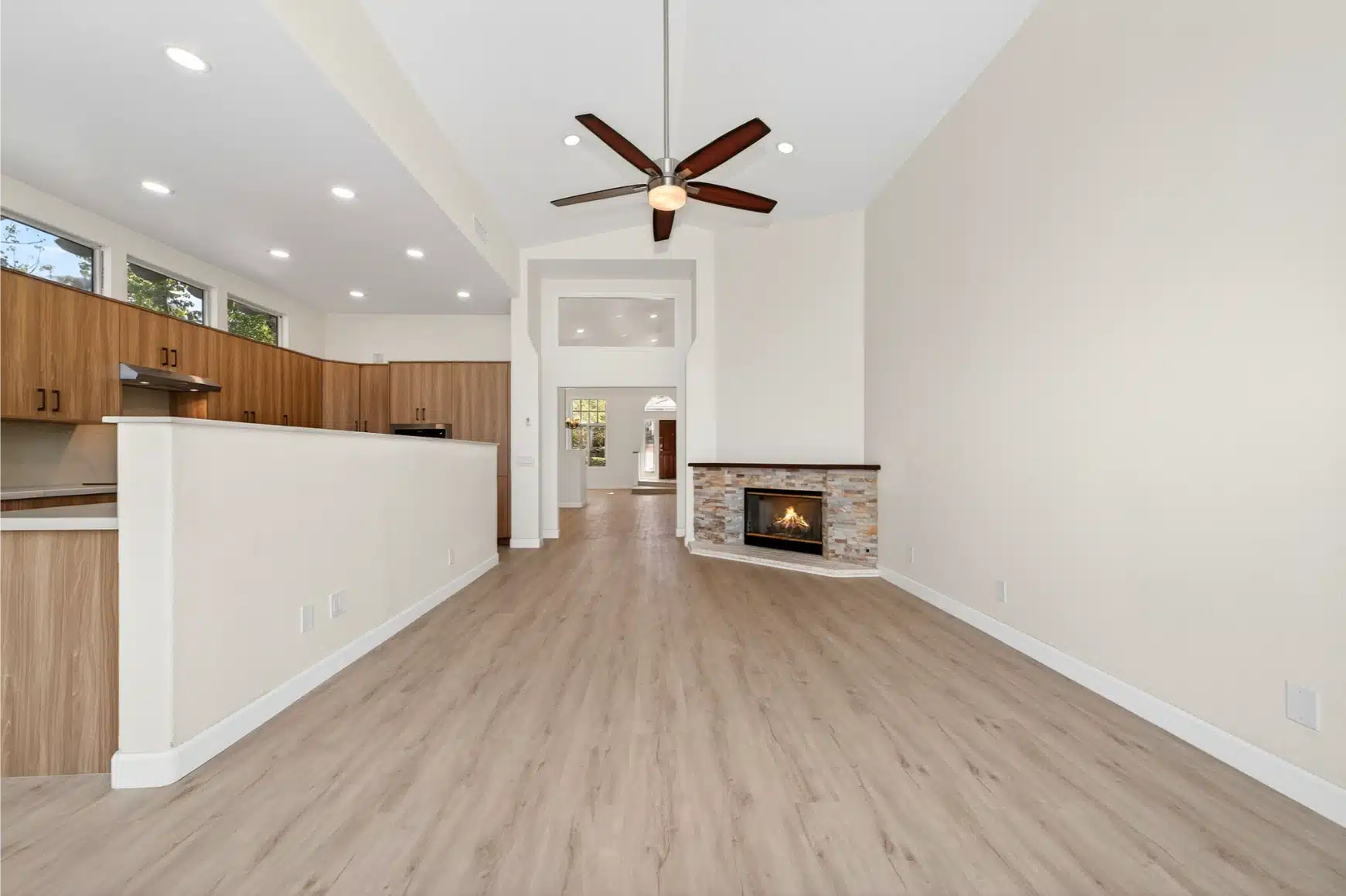 Living area and kitchen from the hall, with the fireplace centred