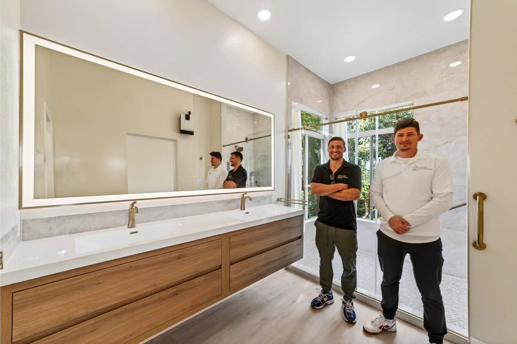 Double vanity and glazed shower wall in the primary bathroom