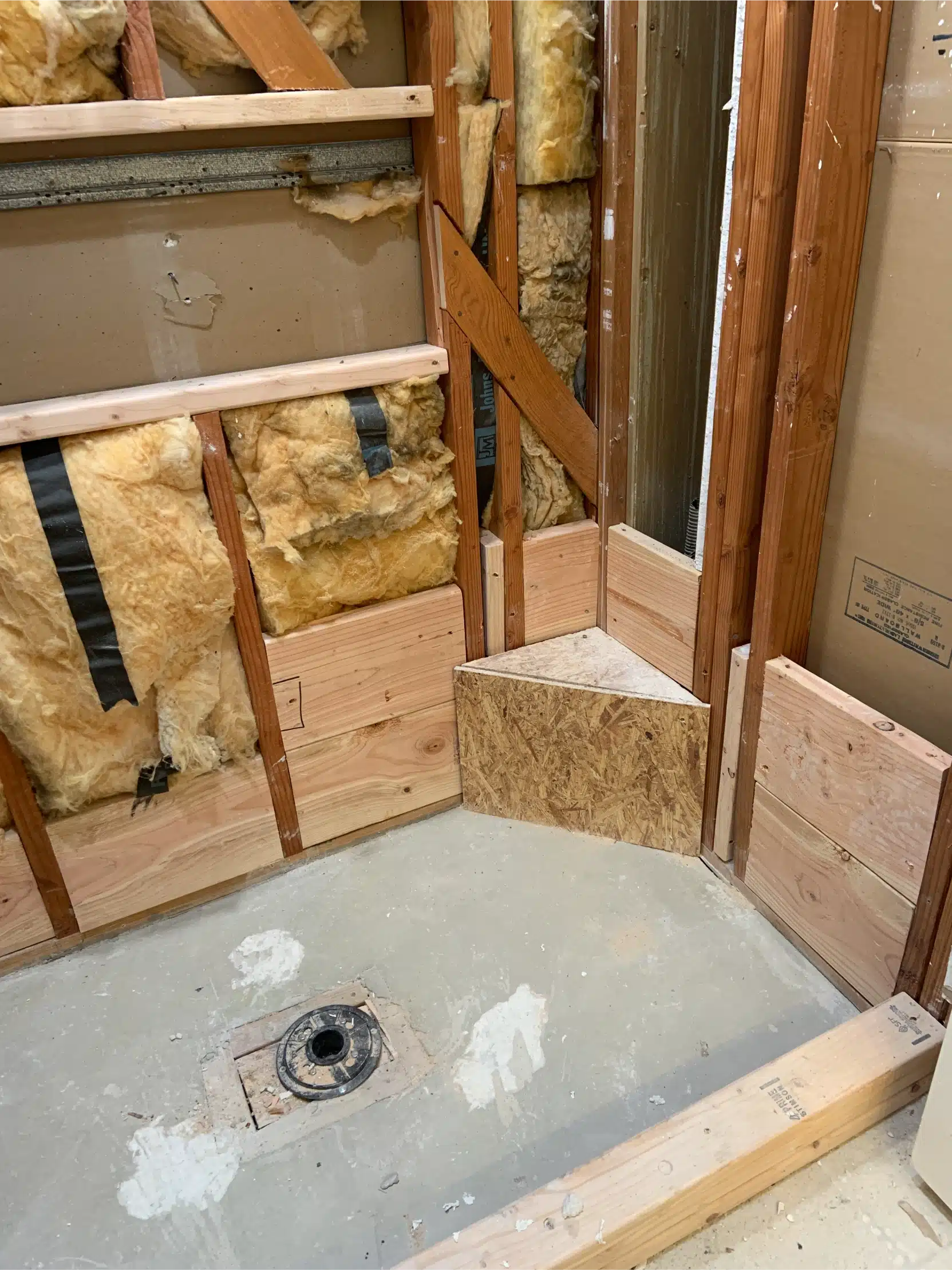 The shower pan formed and the walls prepared before waterproofing