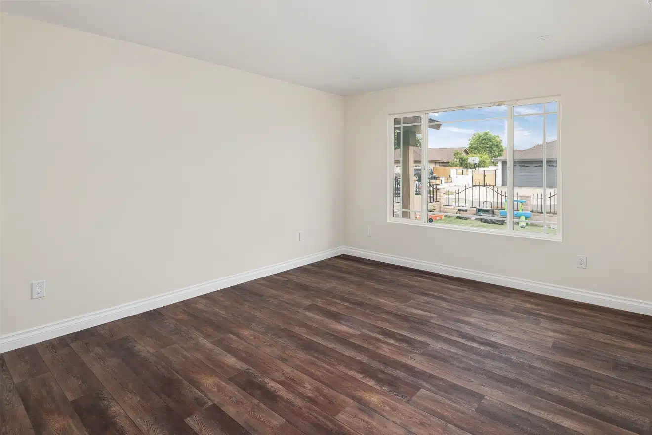 Bedroom with new plank flooring and fresh paint