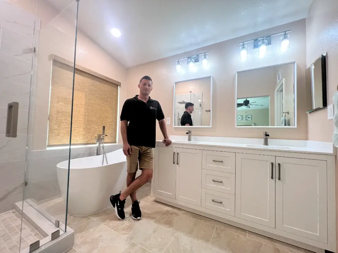 Completed bathroom remodel in Windham, San Diego, with a double vanity, framed mirrors and a vaulted ceiling