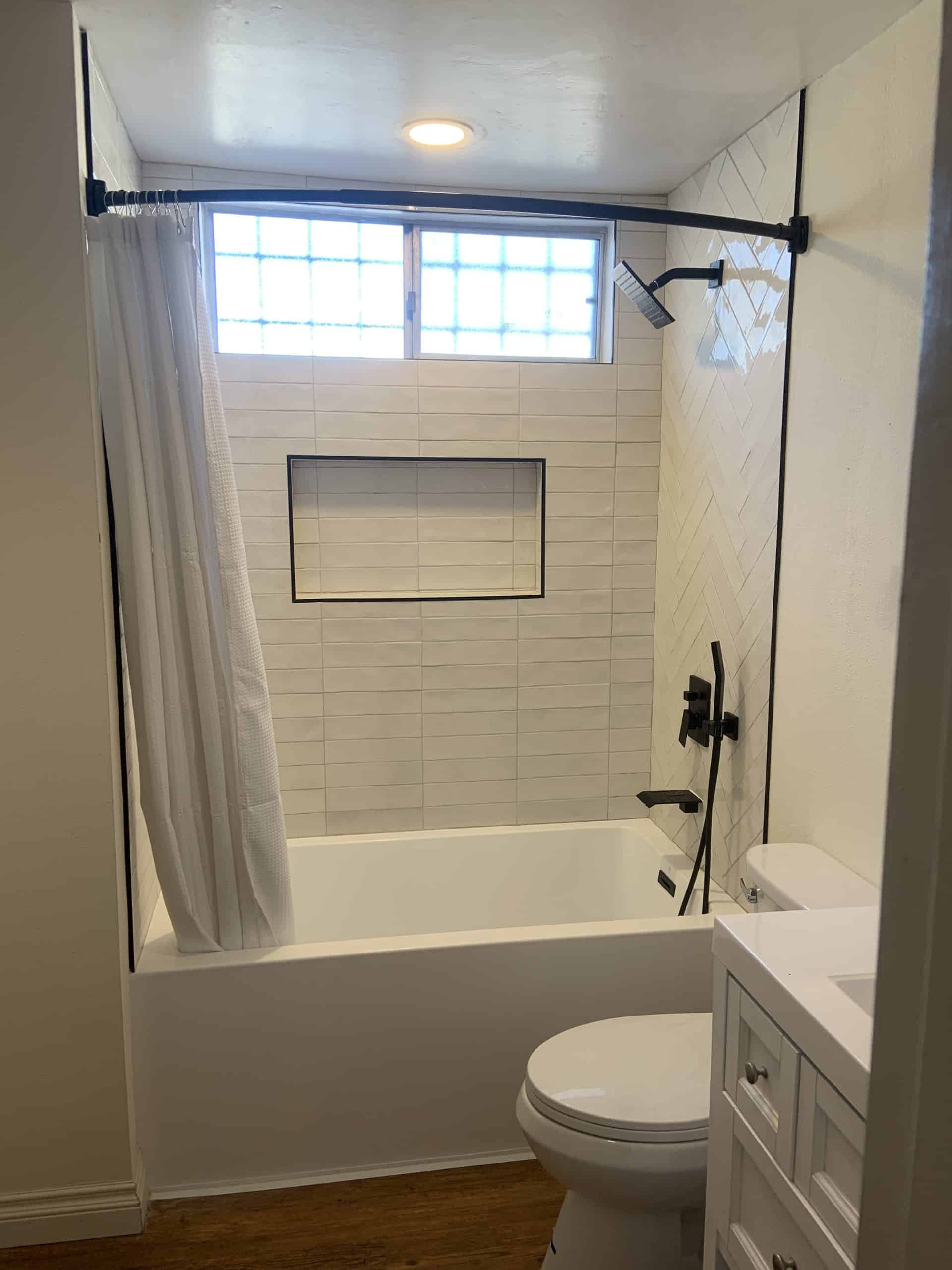 Completed La Mesa bathroom showing the tiled tub surround and new vanity