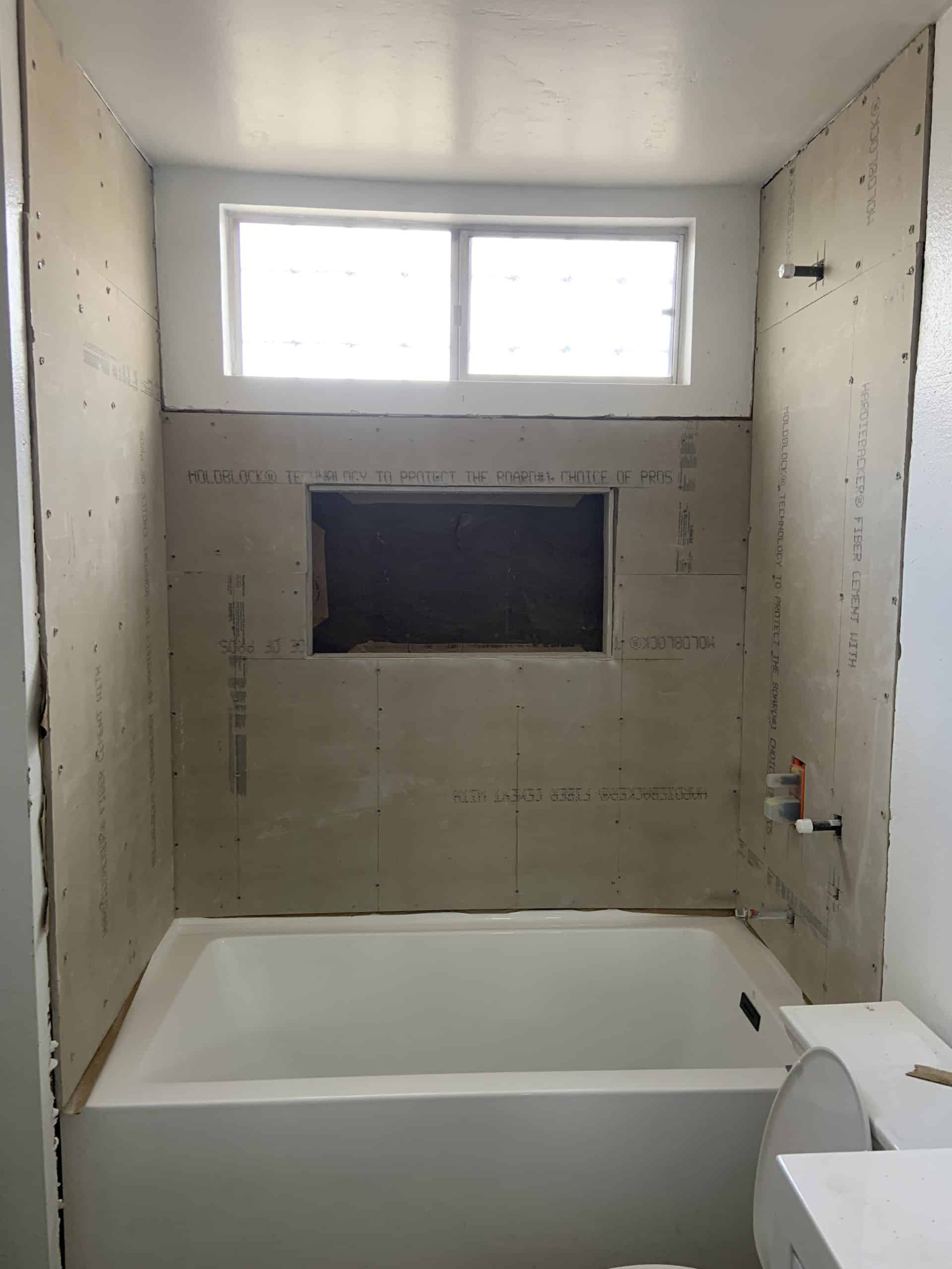 Tub set and the surround tiled with the recessed niche formed, before fixtures were fitted