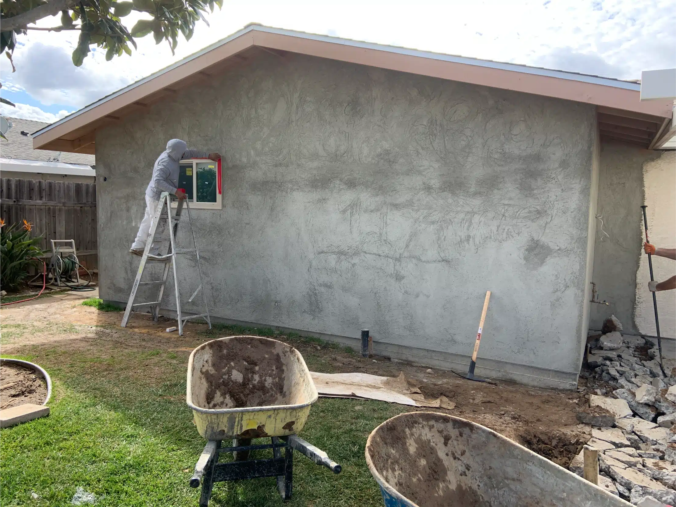 Stucco going on the addition with the scratch coat floated out
