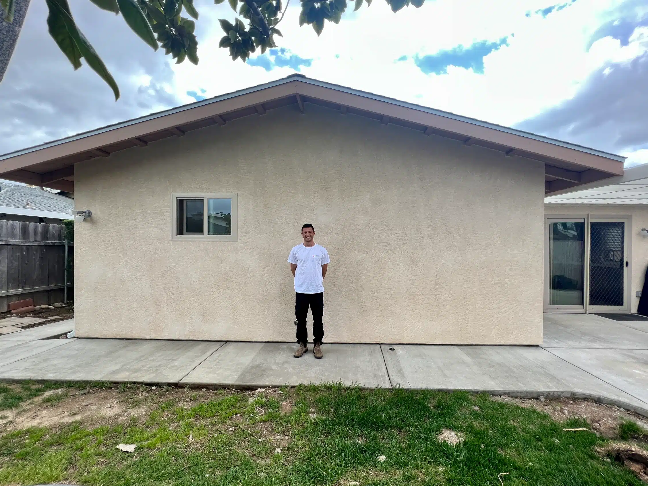 The completed addition from the rear, stuccoed and matched to the original elevation