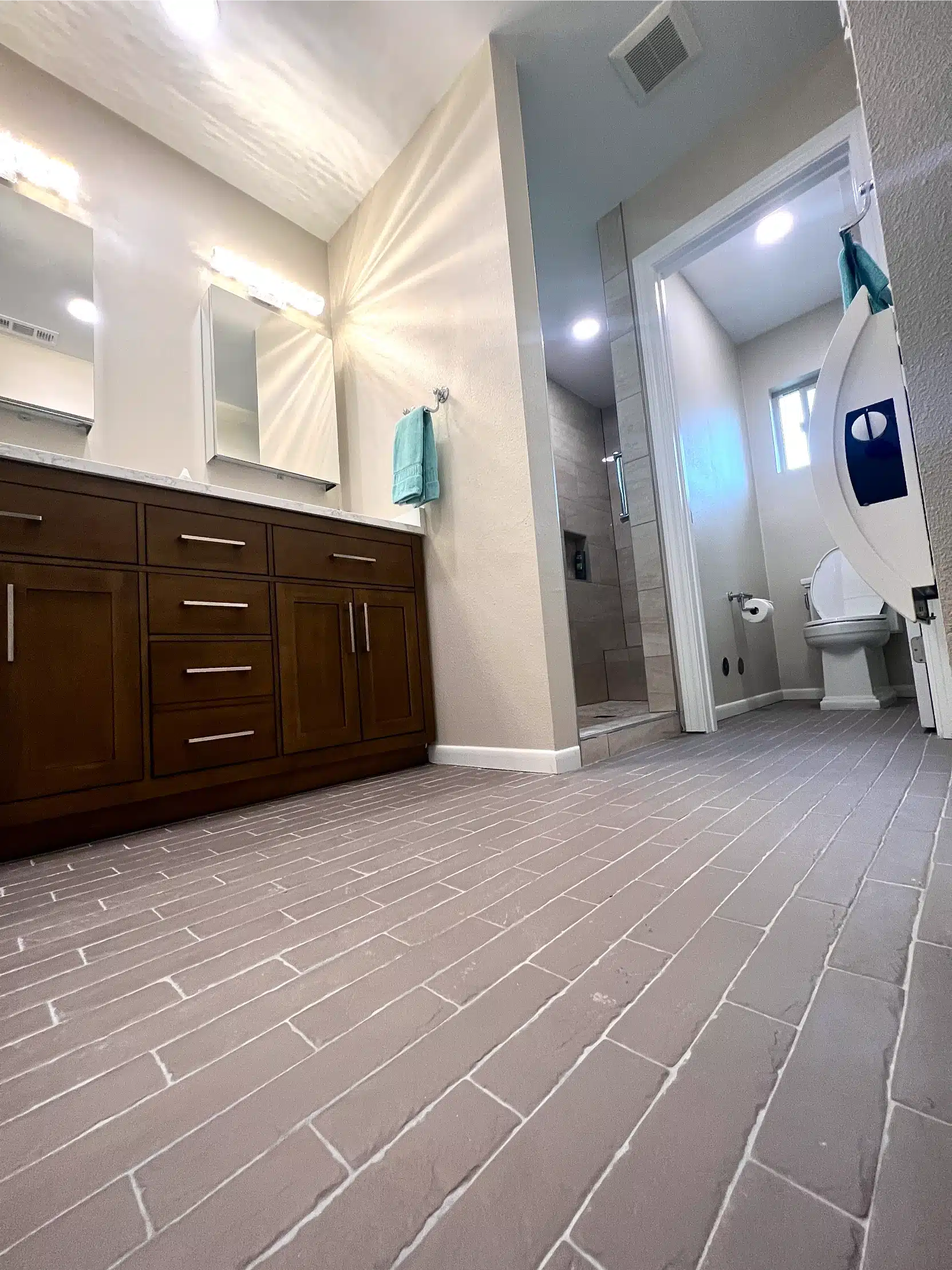 Patterned floor tile running through the new bathroom