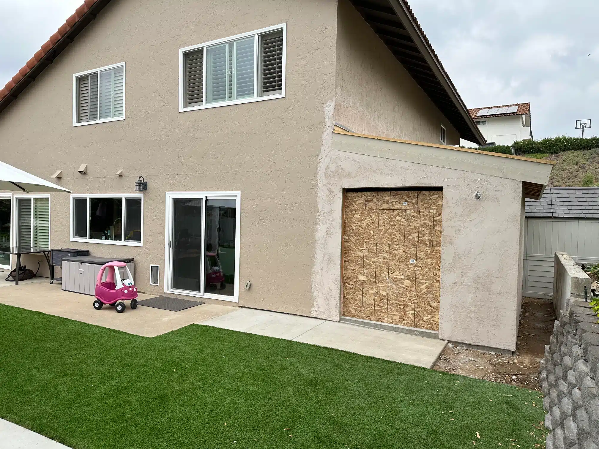 Exterior stucco matched to the existing house, opening still boarded