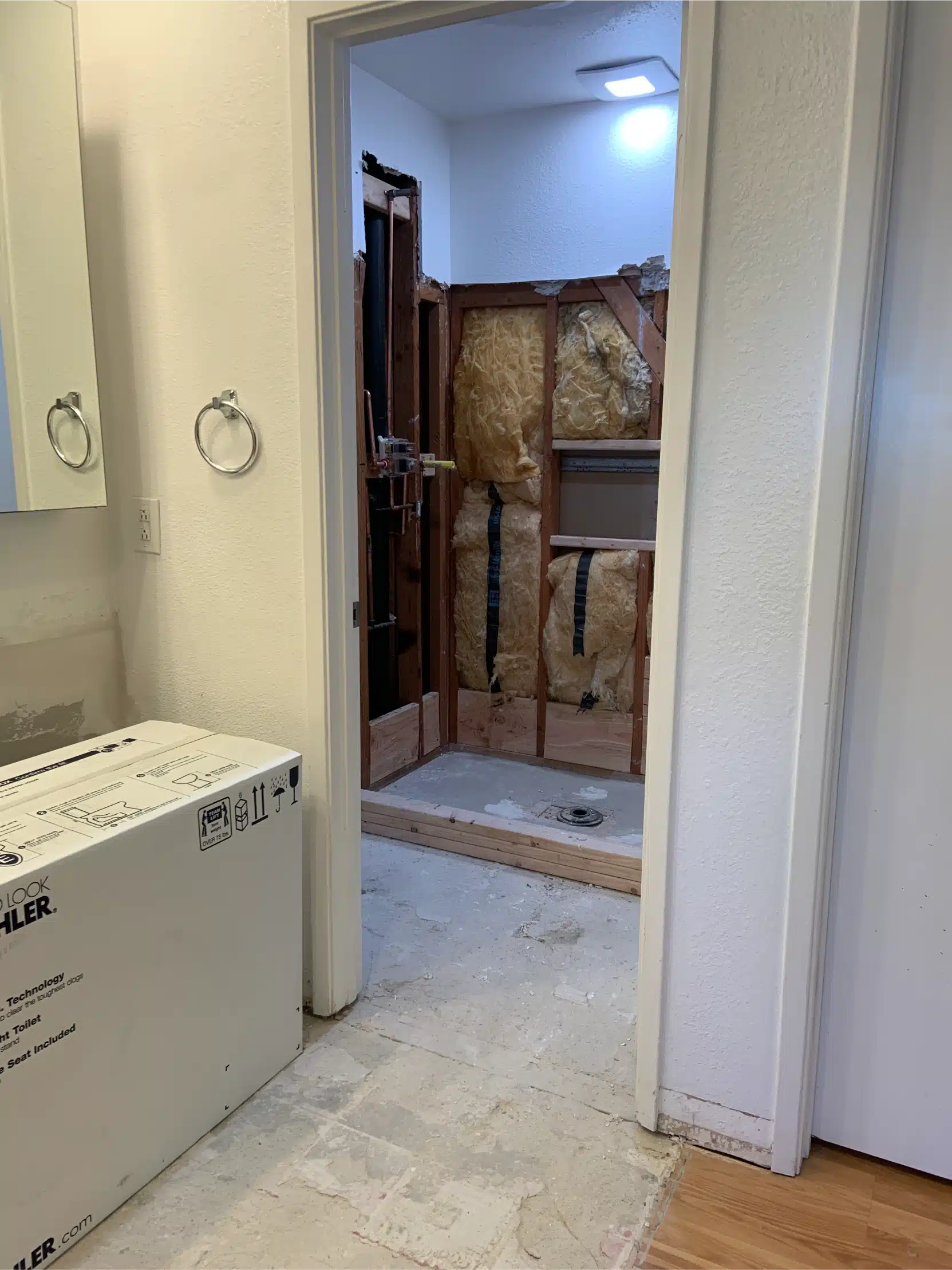 The bathroom part-finished, looking through from the vanity to the shower