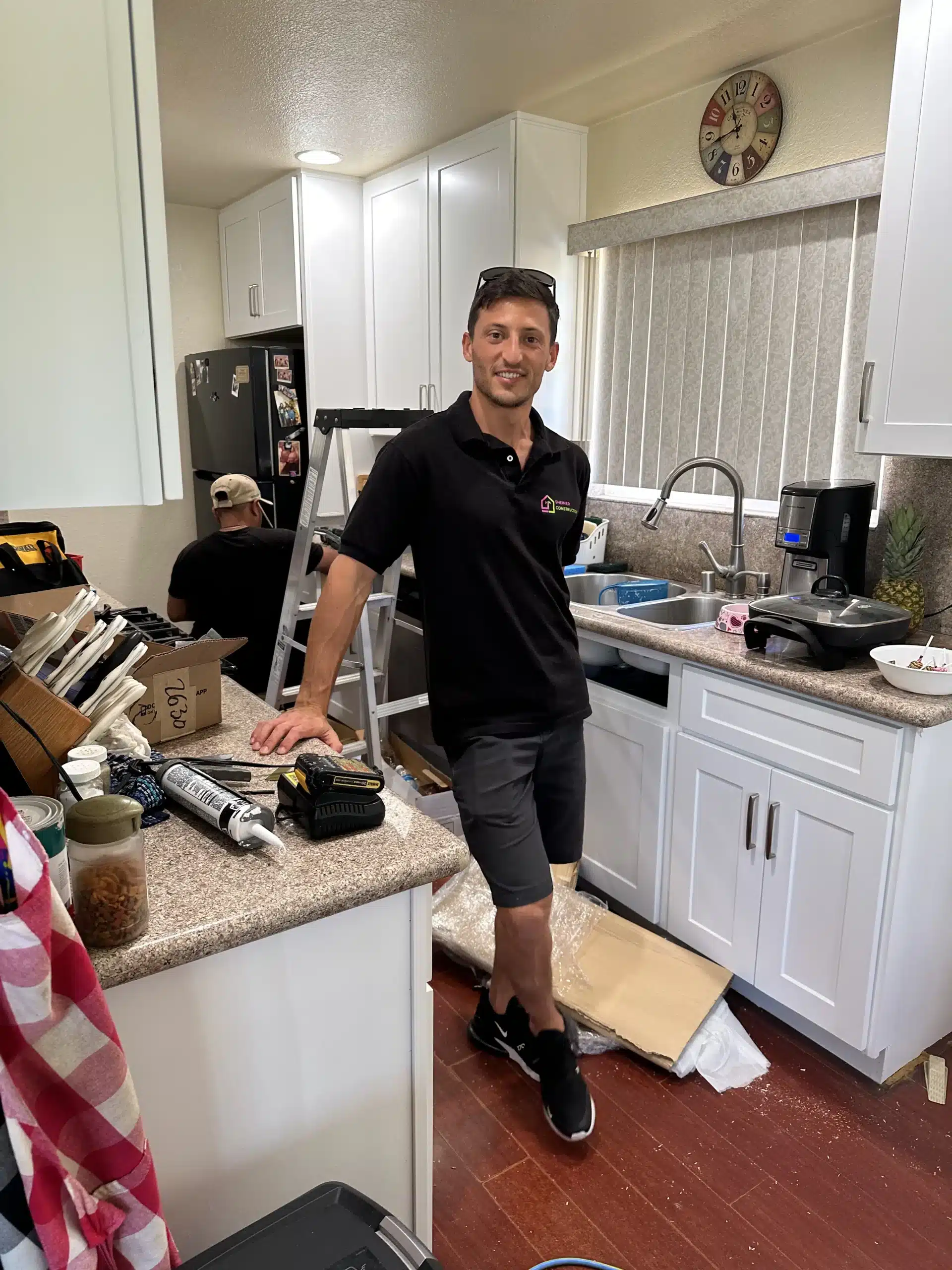 New white cabinetry being installed in the San Diego galley kitchen, with boxes still on the floor