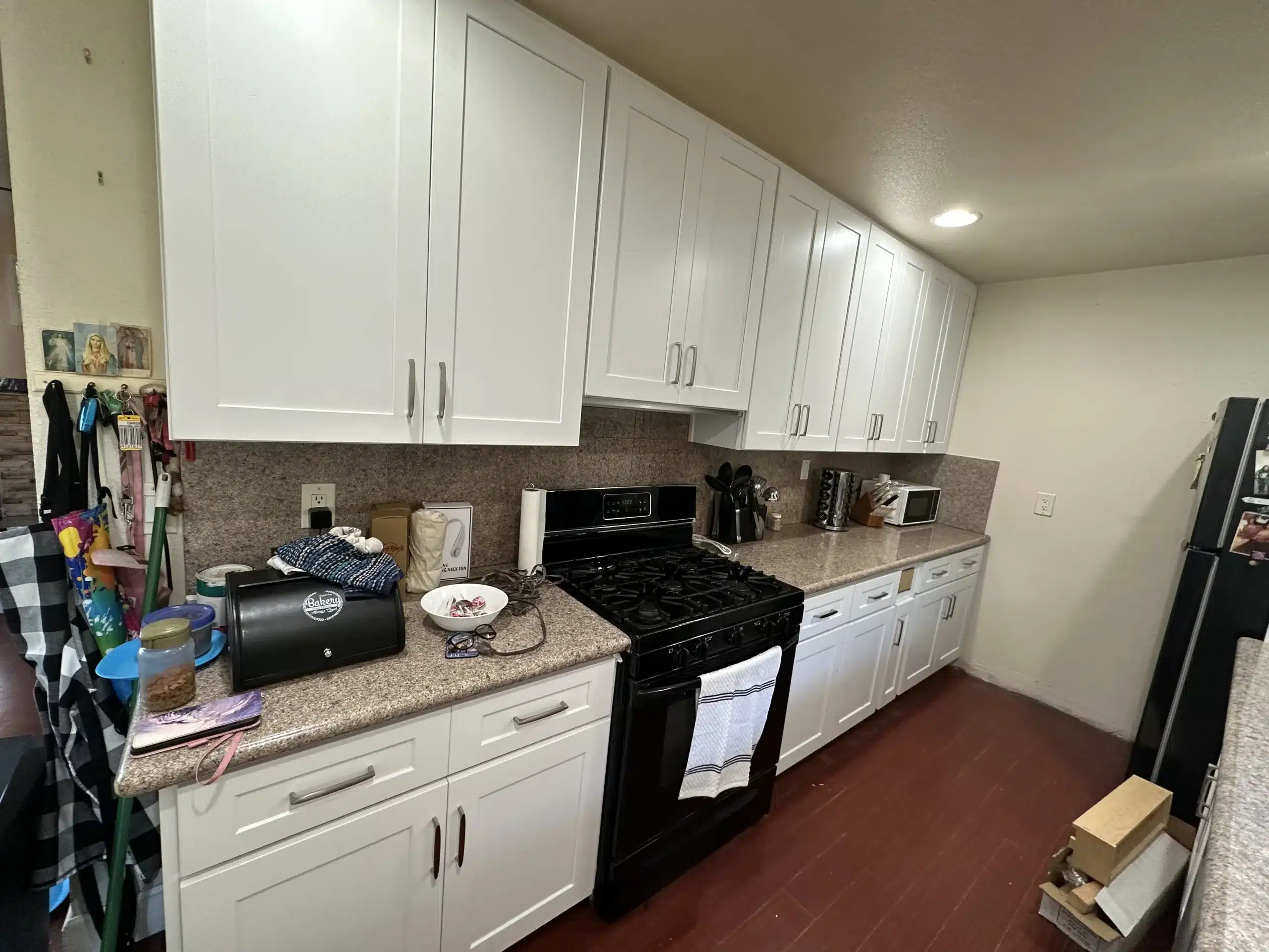 Galley kitchen remodel in San Diego with white shaker cabinetry and a tile backsplash