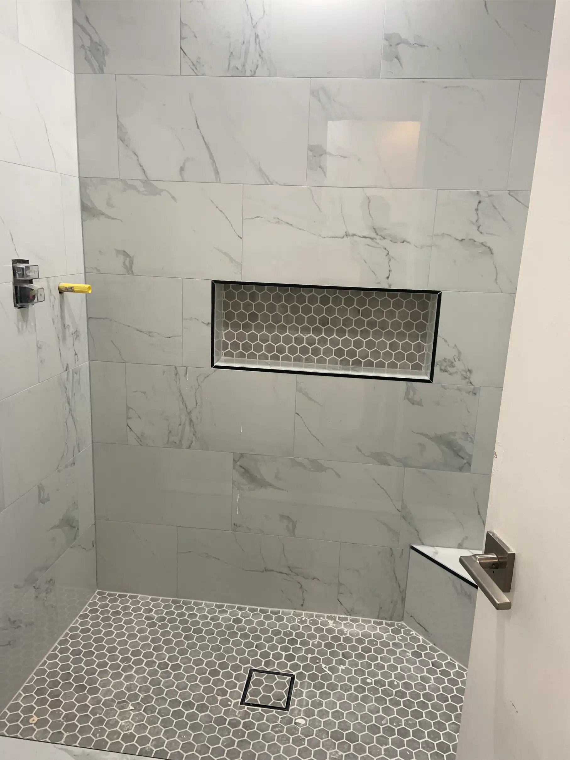 Finished walk-in shower in a San Diego bathroom remodel, with large-format marble-look tile