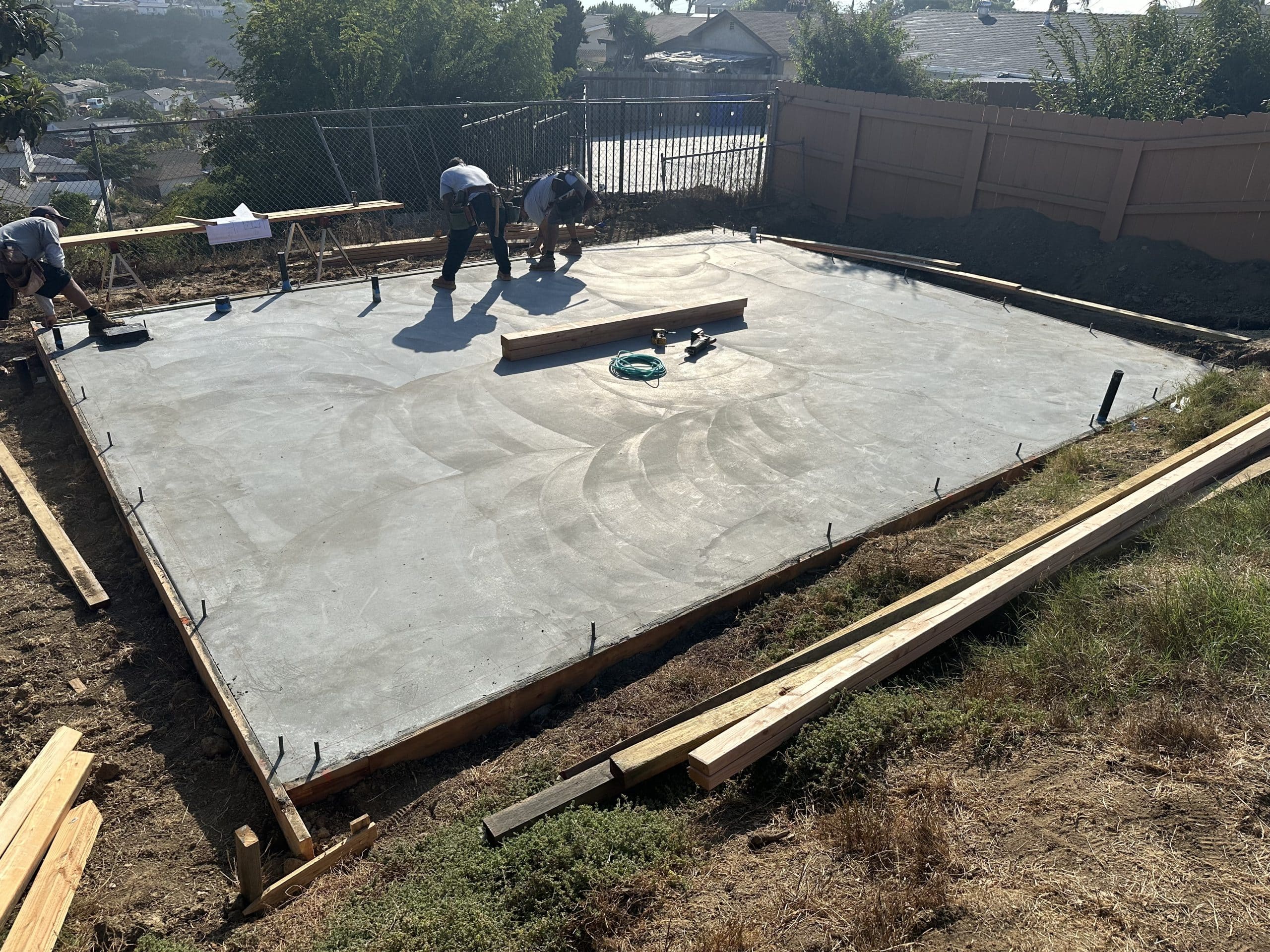 The ADU slab poured and formed in the rear yard, with the perimeter set out