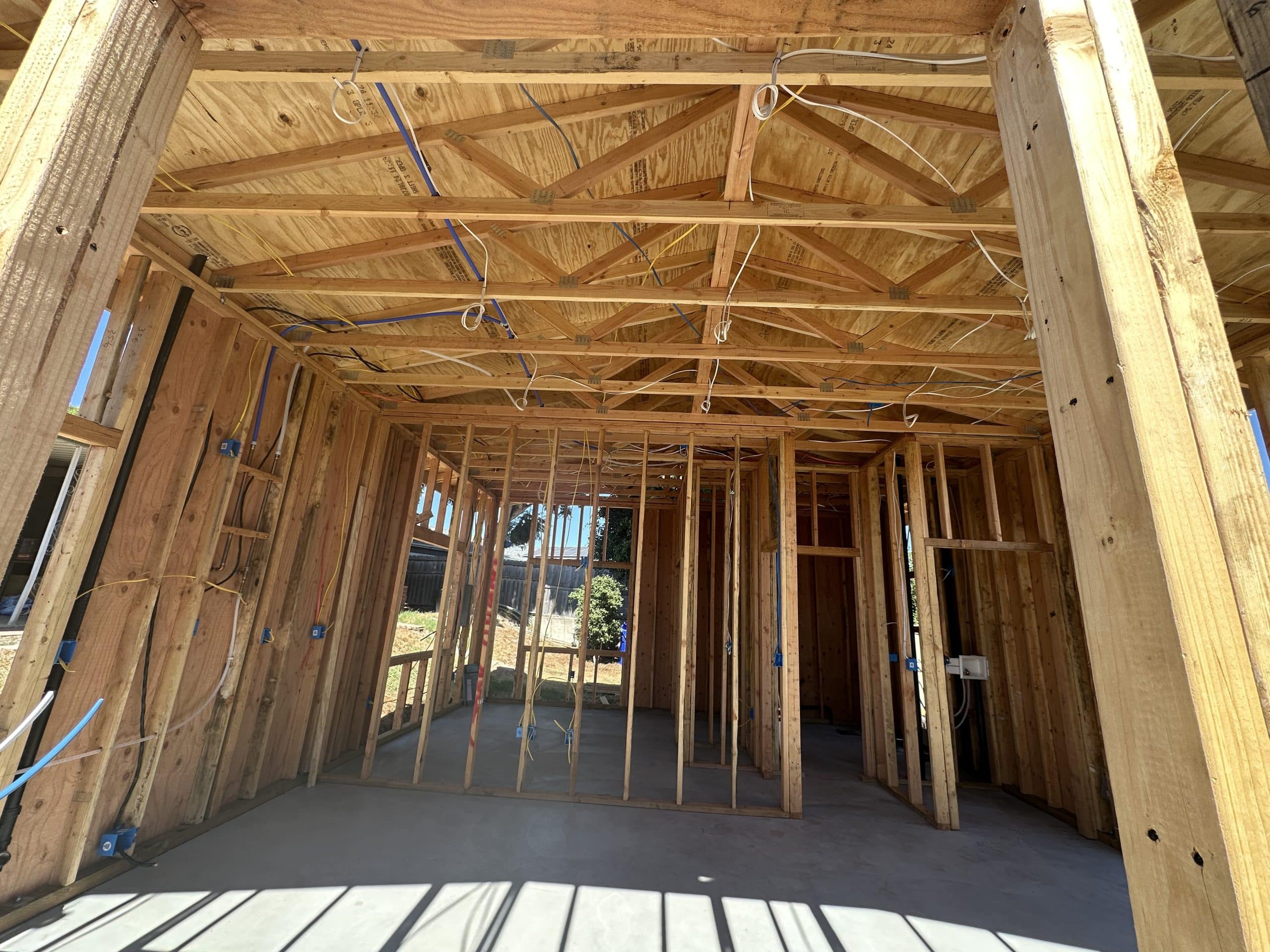 Interior framing of the ADU with the roof structure above and openings formed