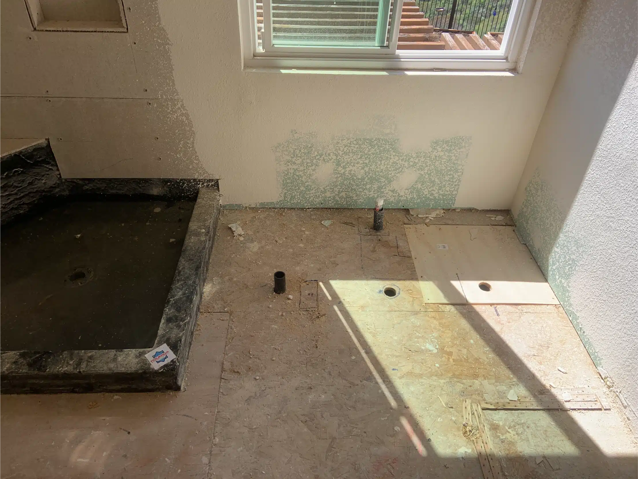 The shower pan formed and the subfloor prepared before waterproofing