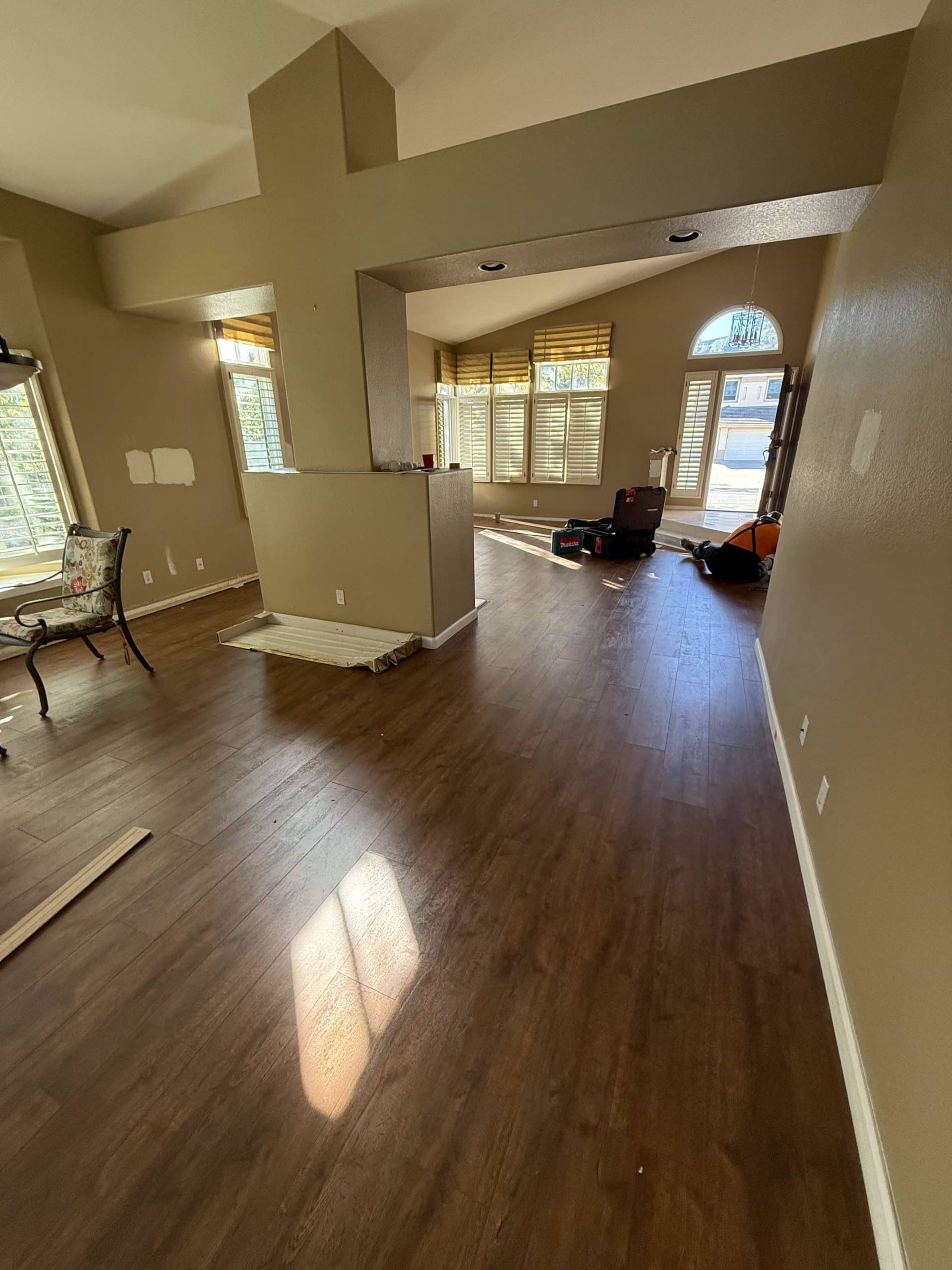 The living area before the remodel, with the vaulted ceiling and dark timber flooring already in place