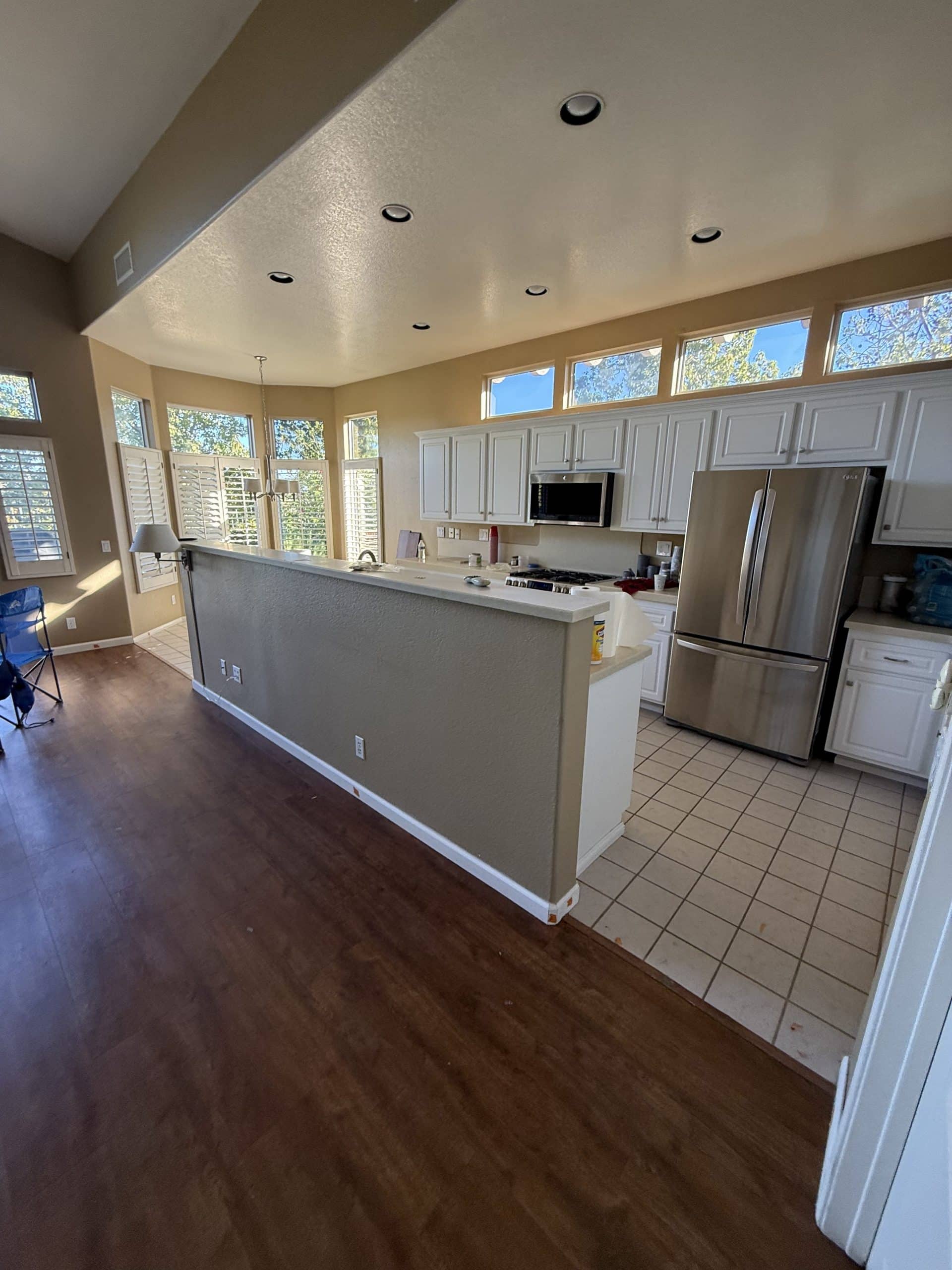 The original kitchen before the remodel, with a tiled counter peninsula closing off the room