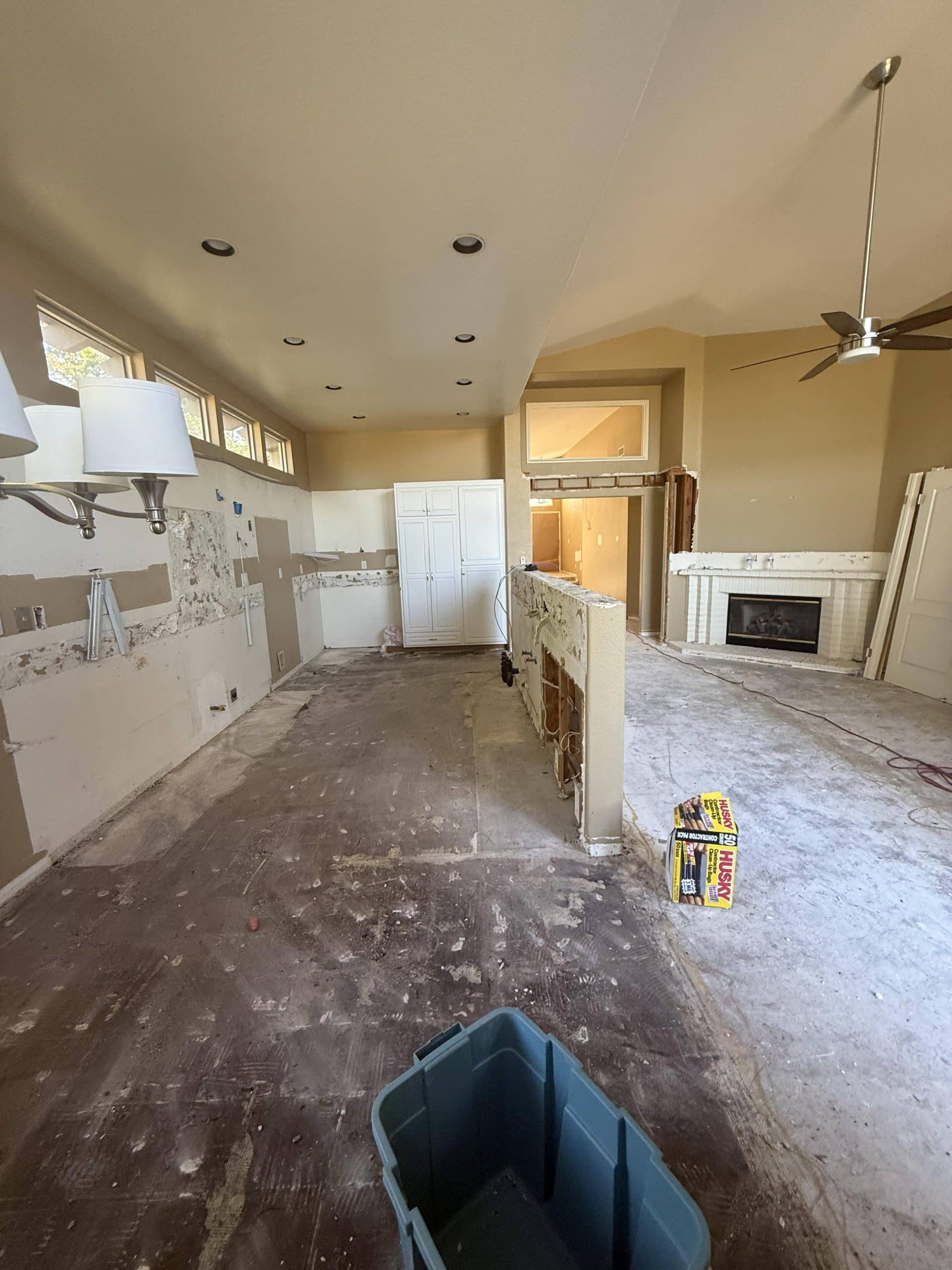 The open plan stripped back, looking through to the fireplace wall