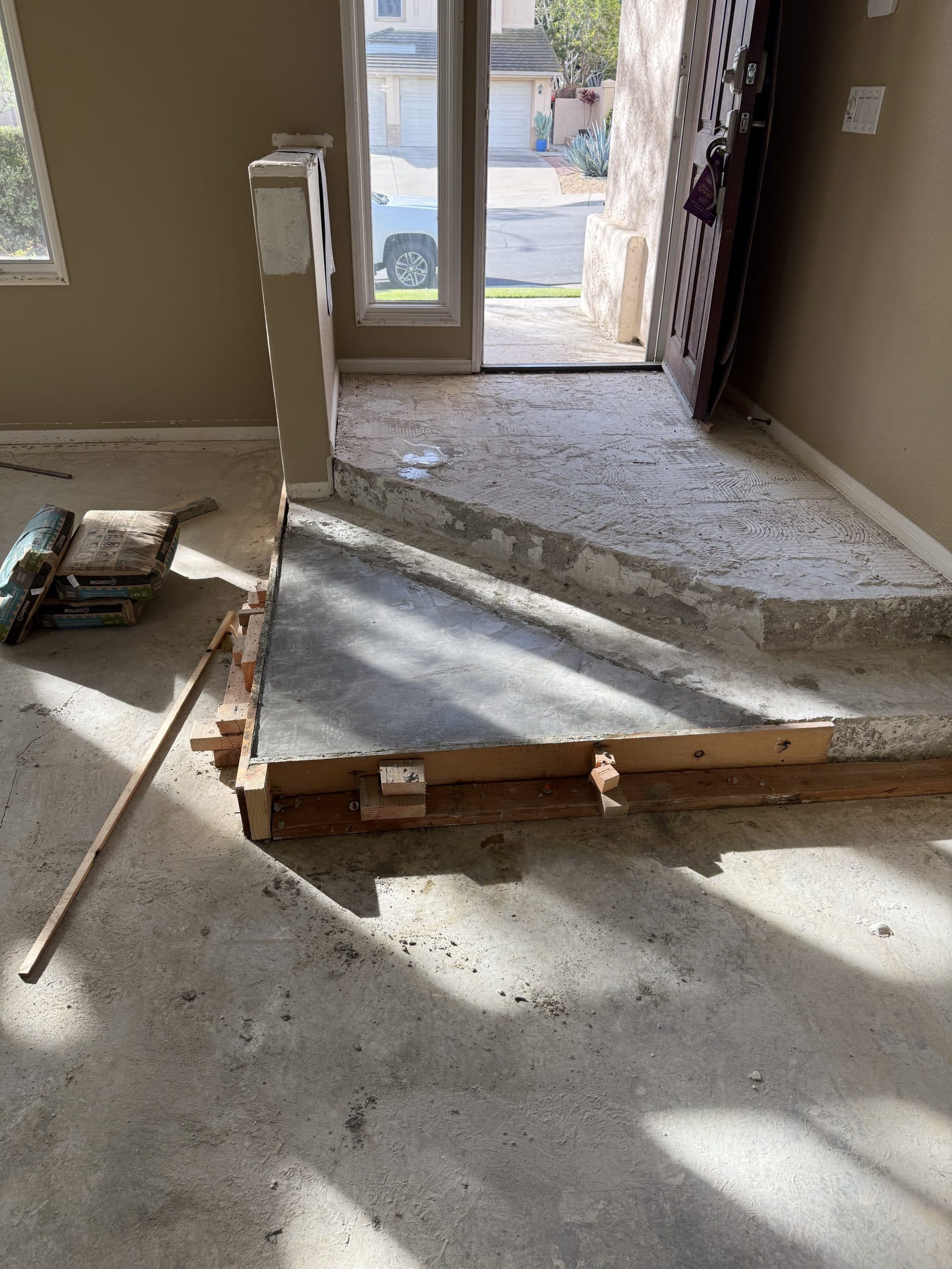 The floor stripped back to the slab across the whole plan