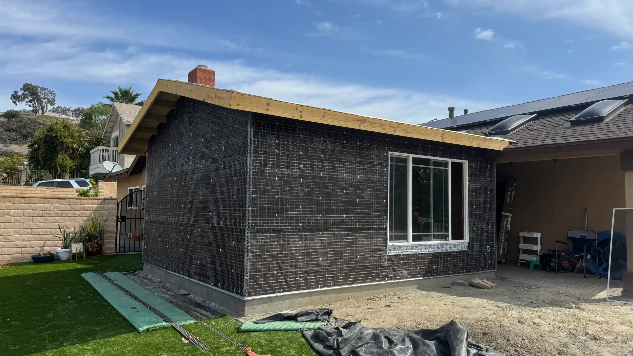 The addition wrapped in building paper with windows installed