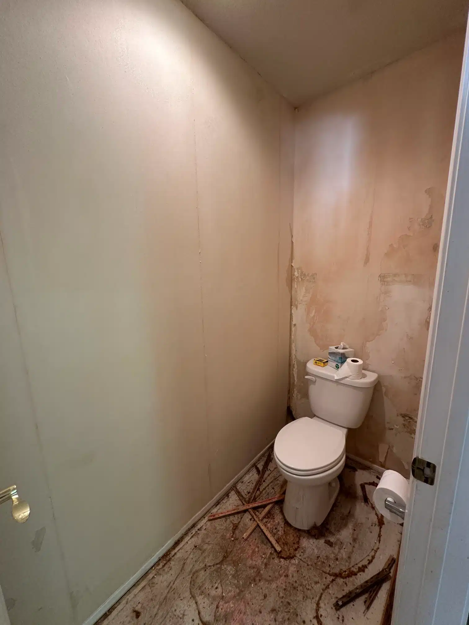 The original cloakroom stripped back with the fixtures removed