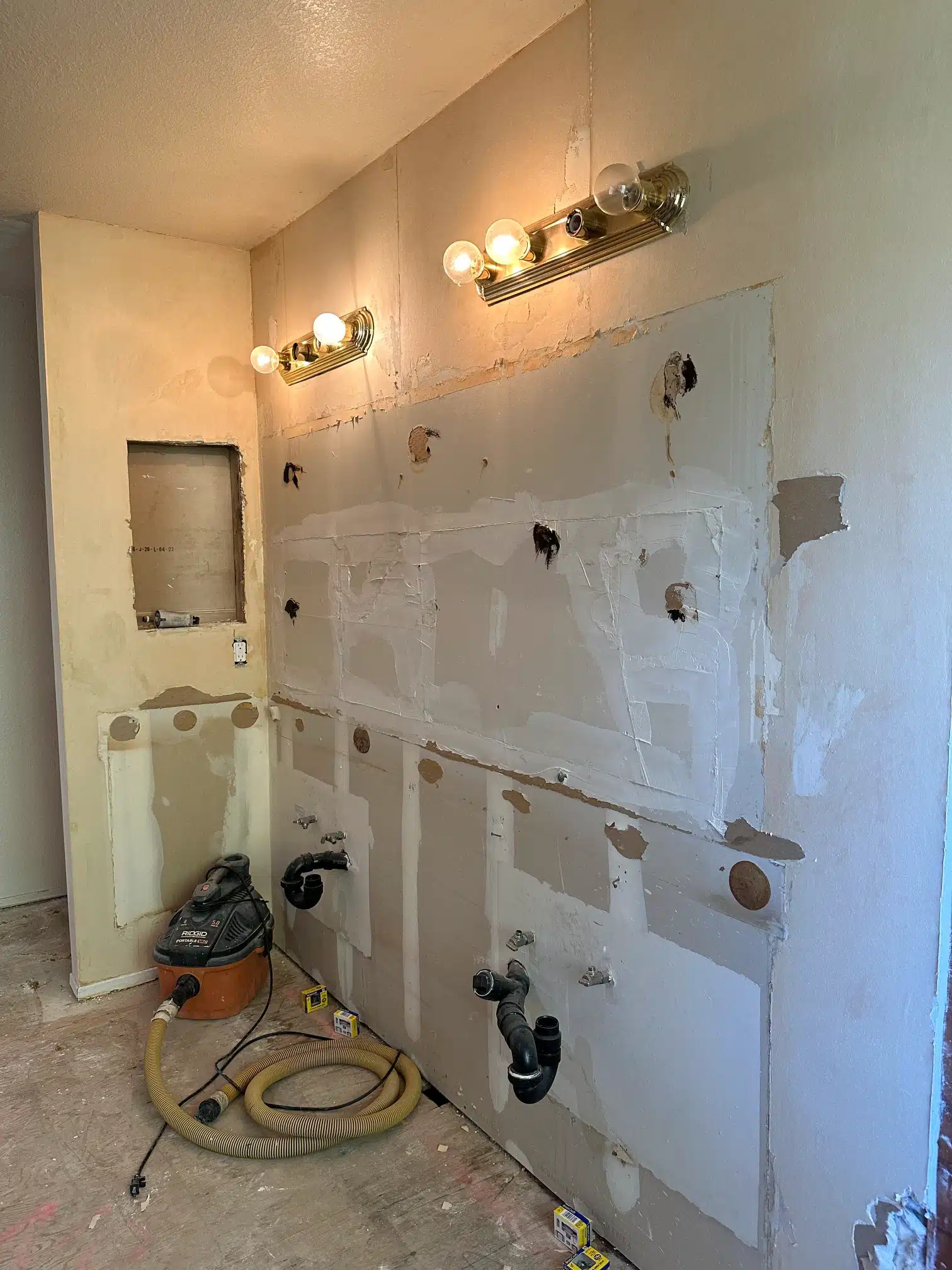 The stripped bathroom with services roughed in and the walls open