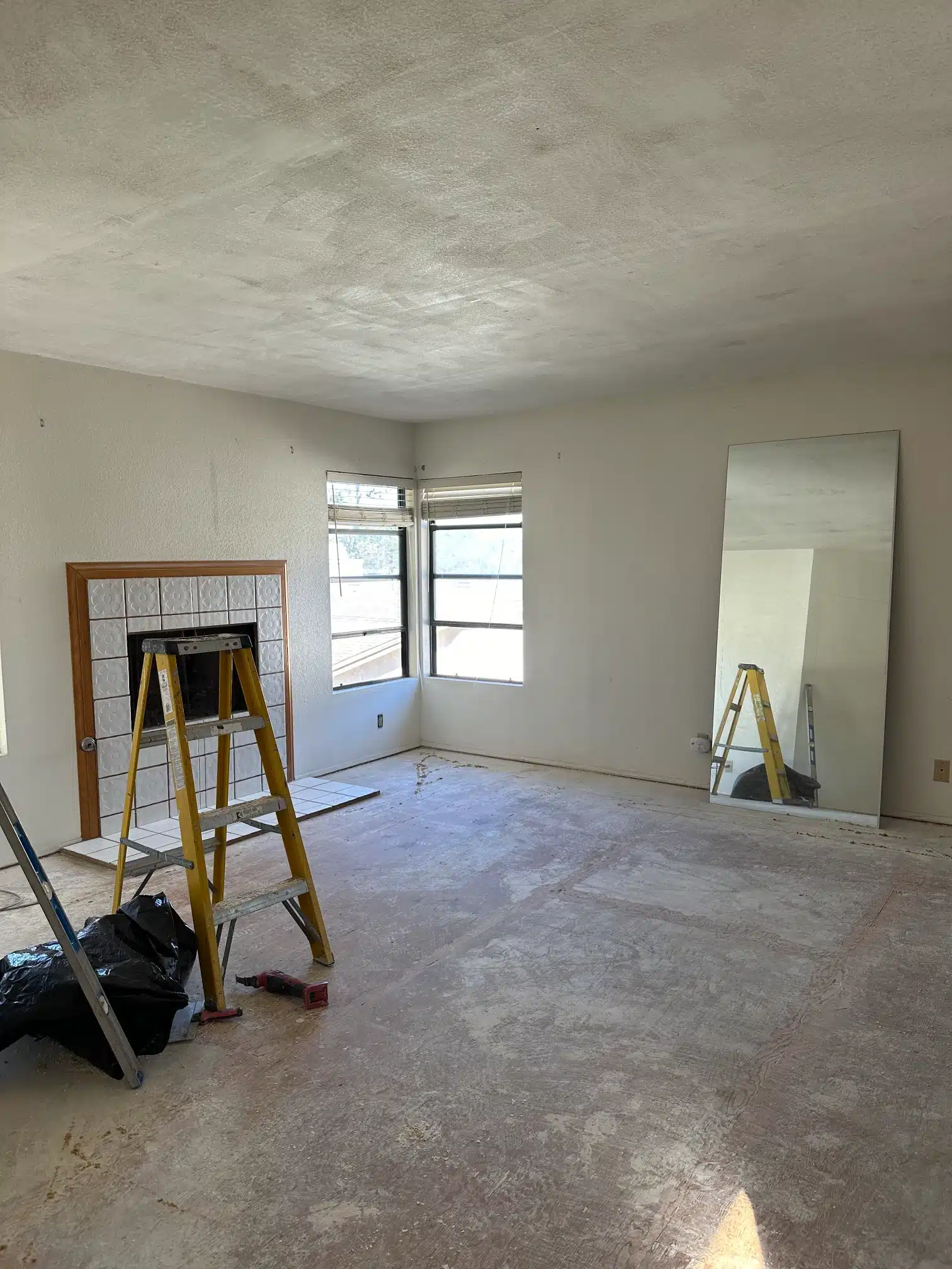 The living area stripped back to the subfloor with the ceiling and walls prepared