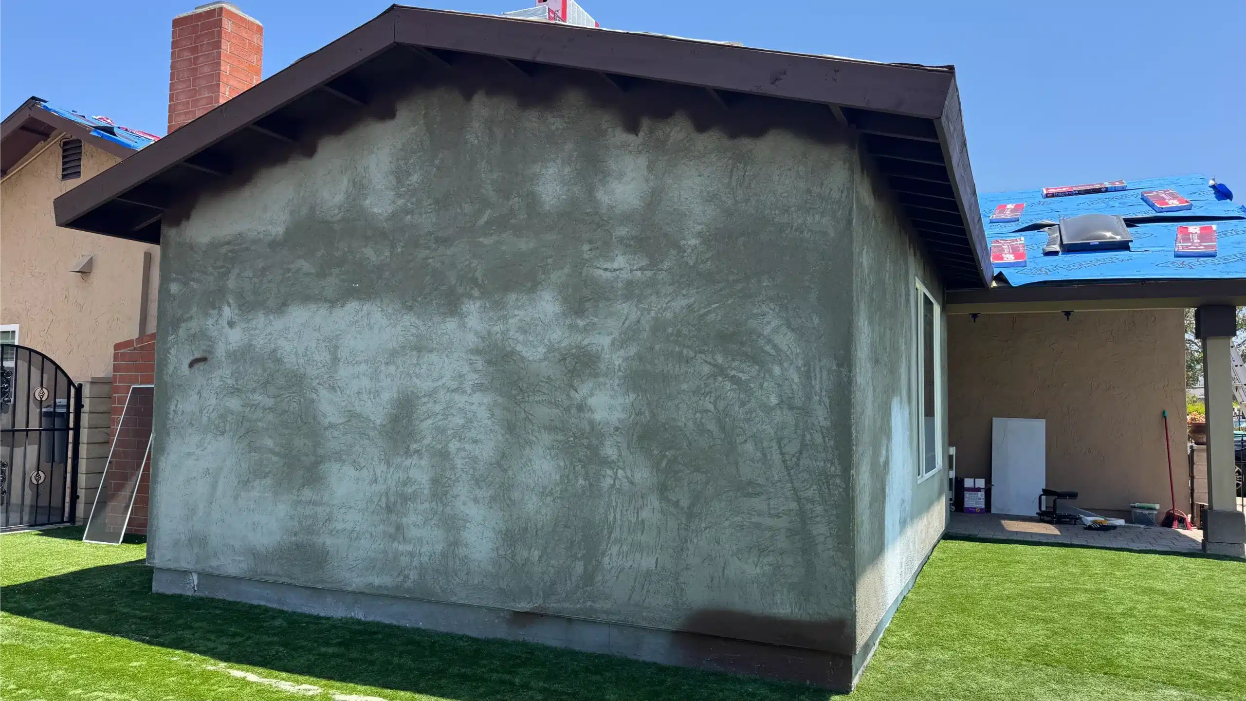 The addition rendered in stucco, floated flat and ready for the finish coat