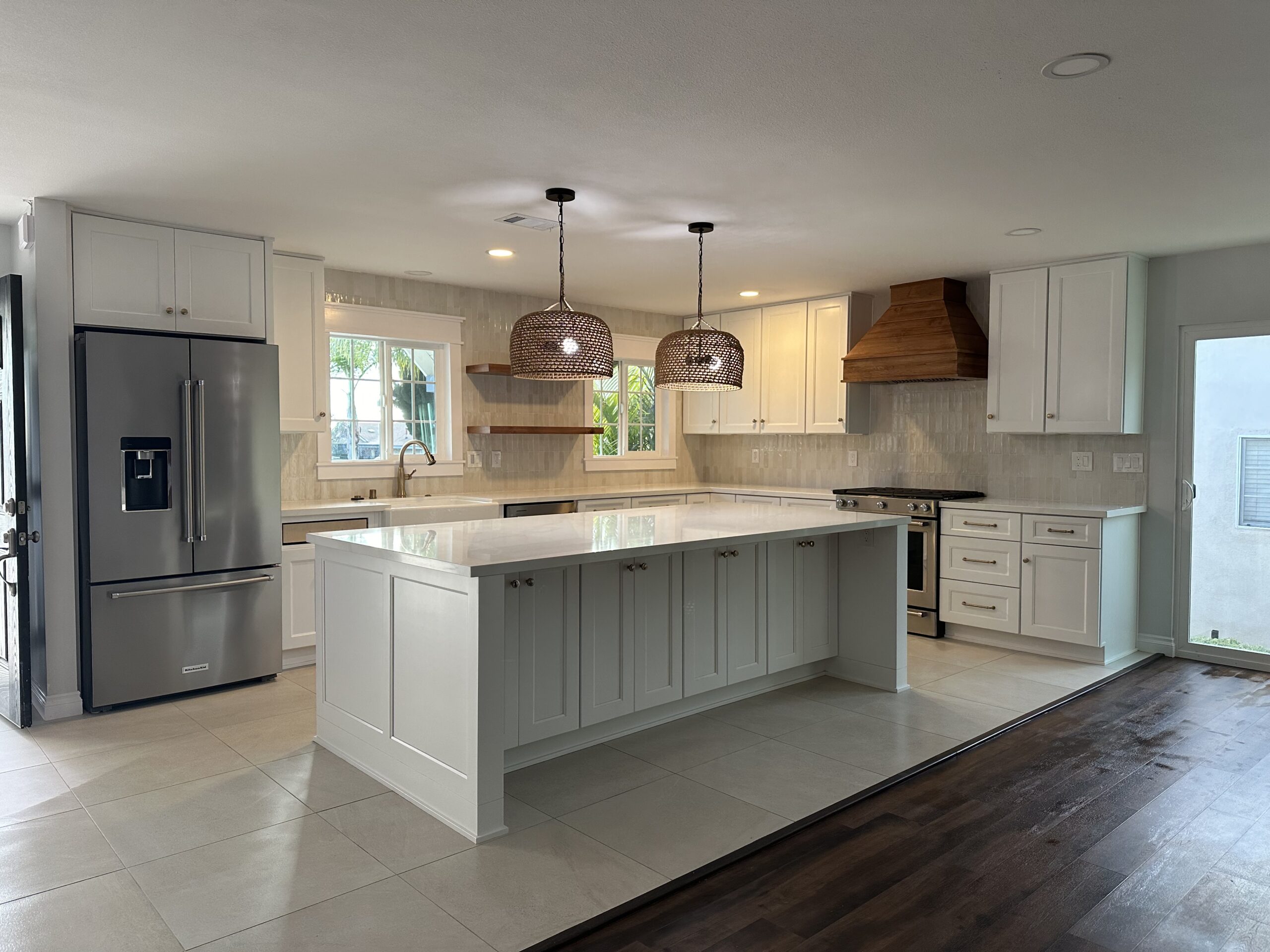 Completed San Diego kitchen remodel with a white island, pendant lighting and shaker cabinetry