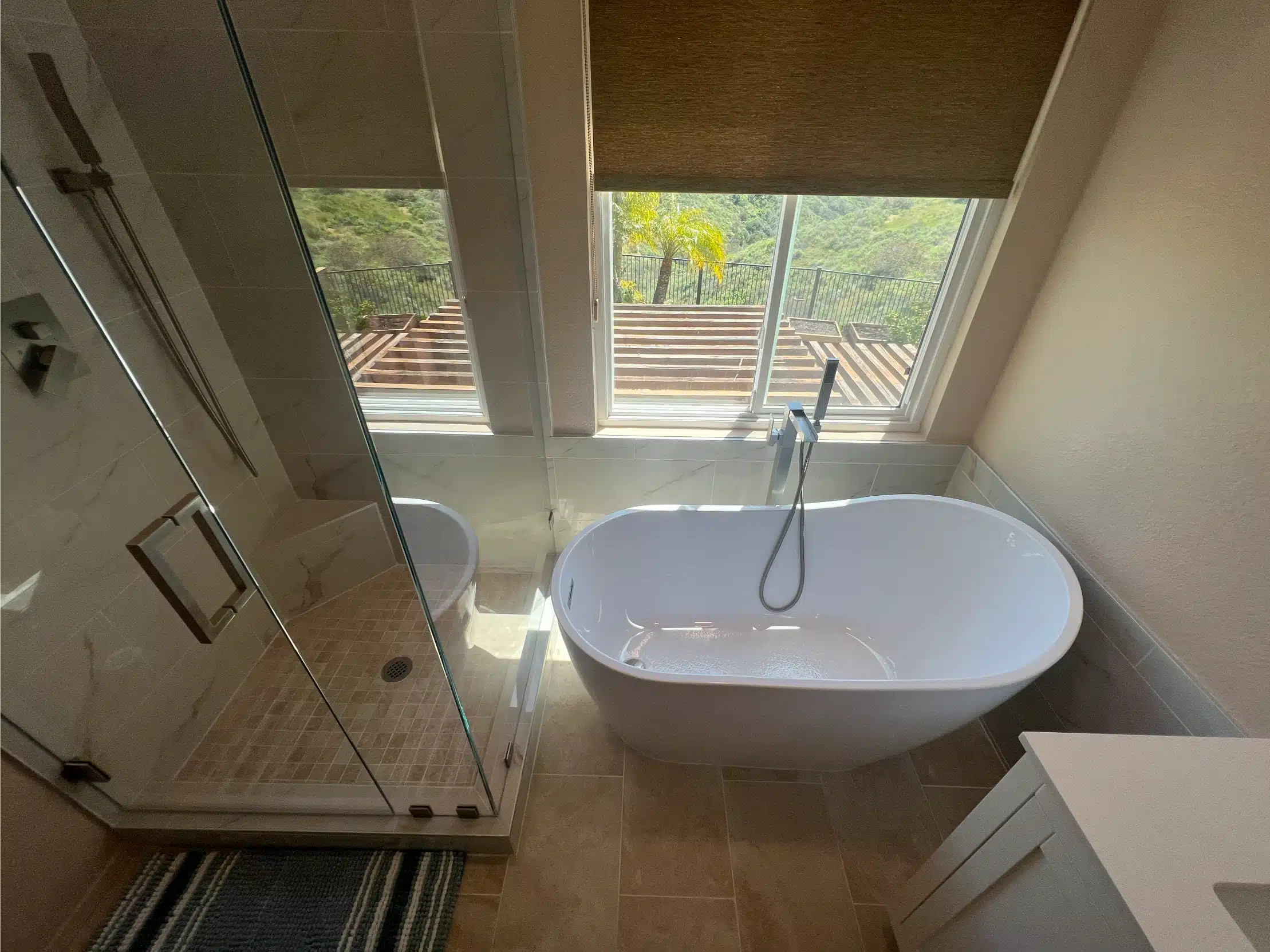 The freestanding tub beneath the window, with the shower alongside