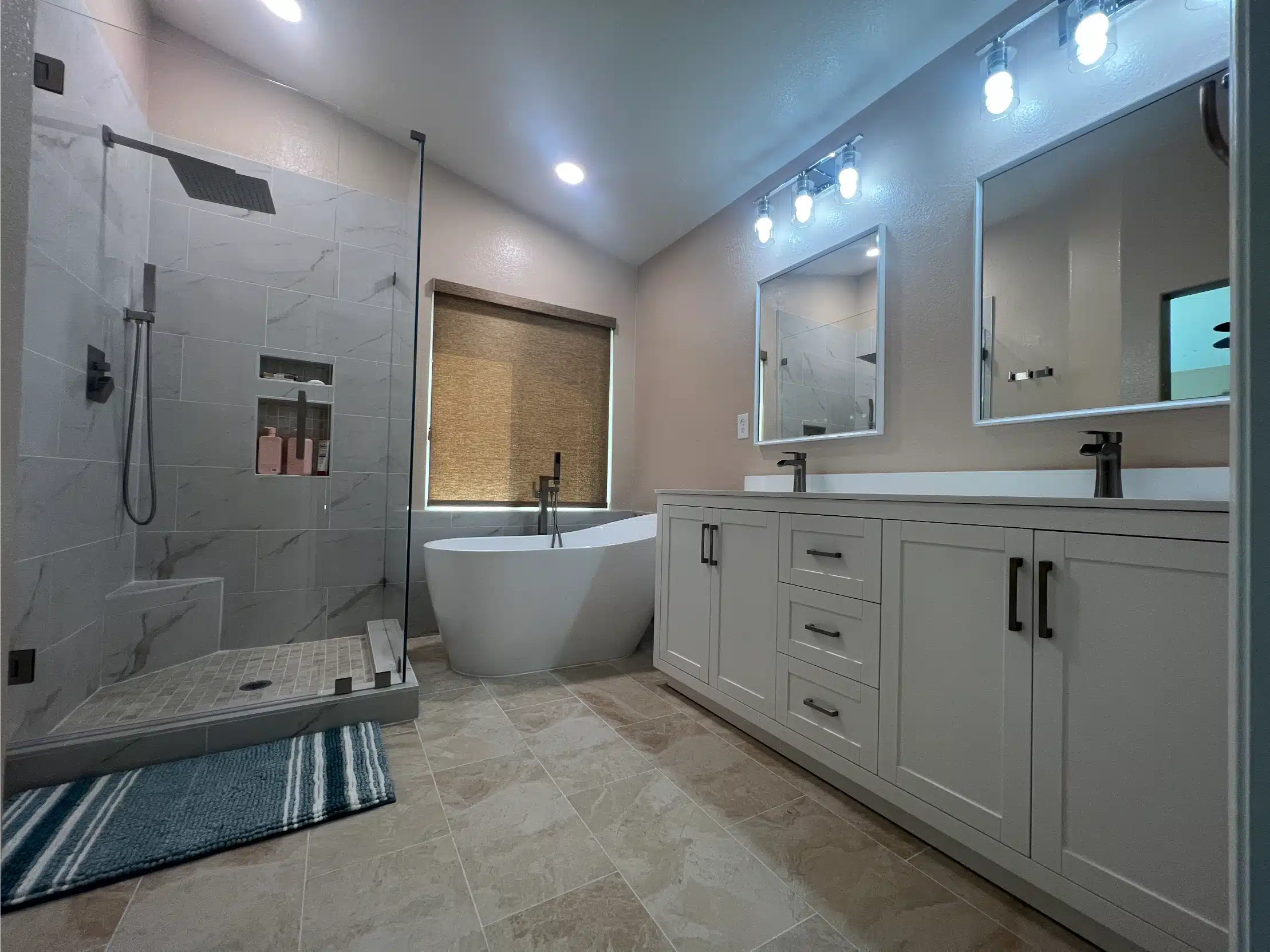 Primary bathroom with a freestanding tub, curbless shower and double vanity