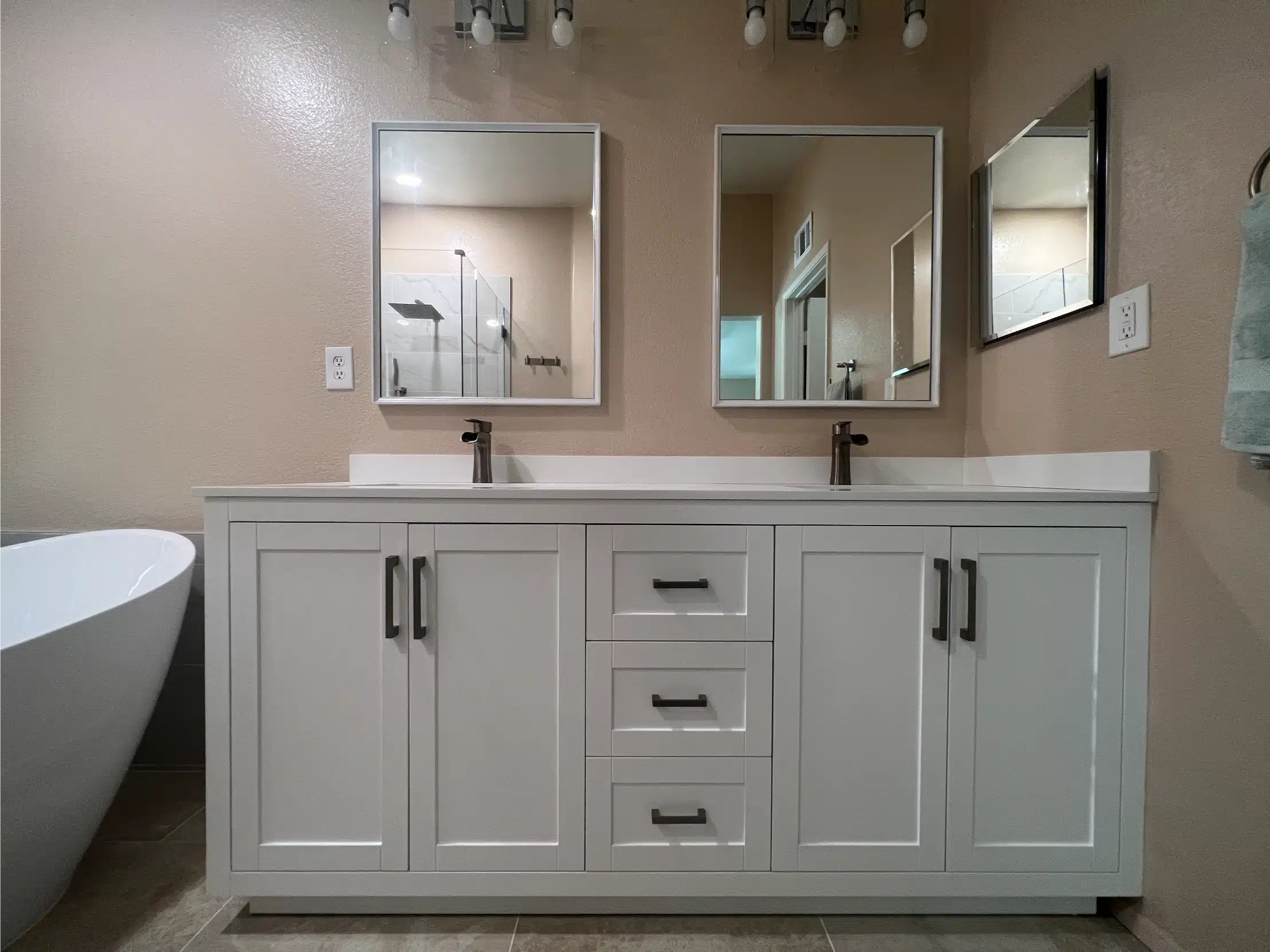 The double vanity with twin mirrors facing the tub