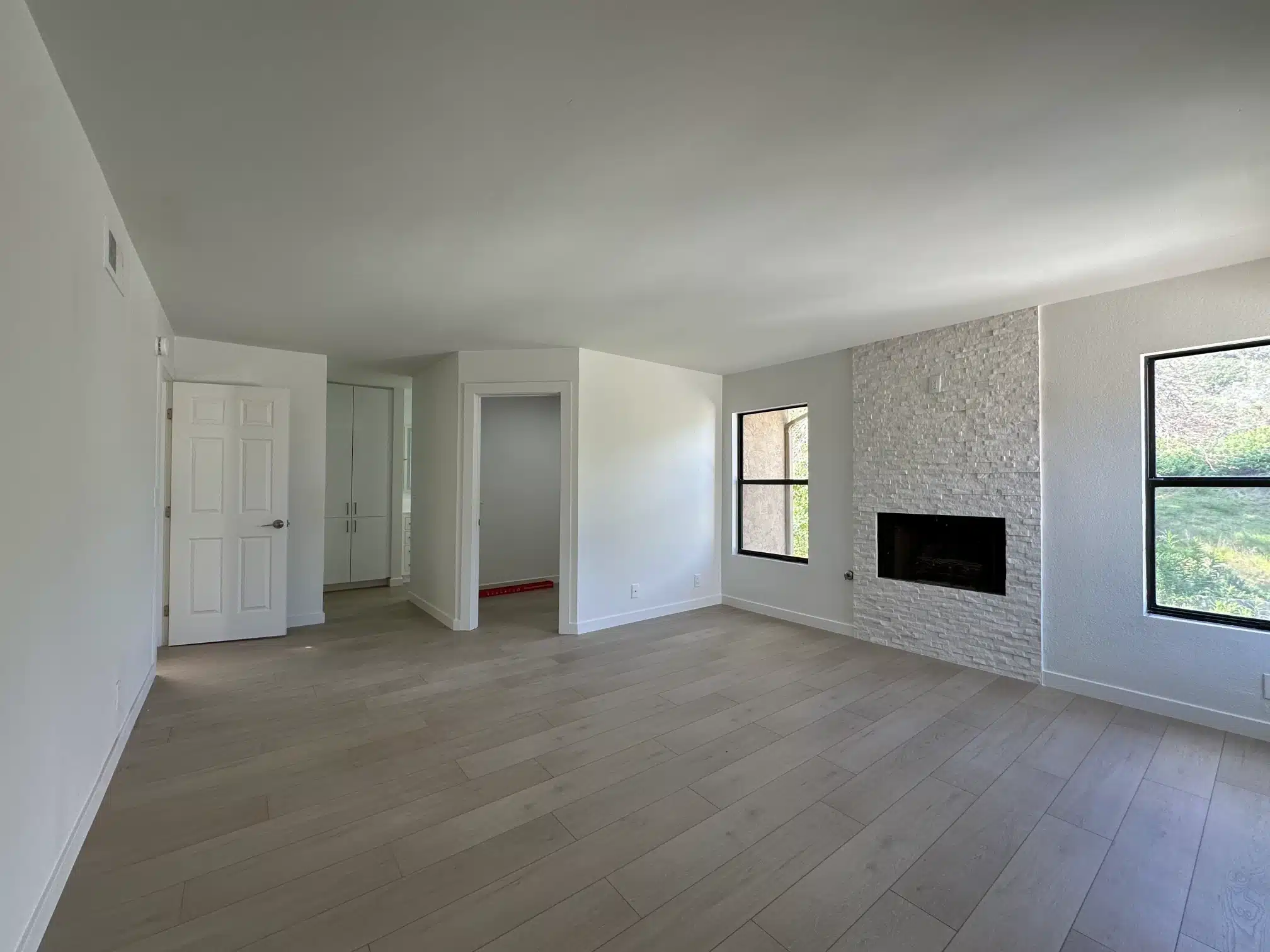 The finished living room with the rebuilt fireplace and new flooring