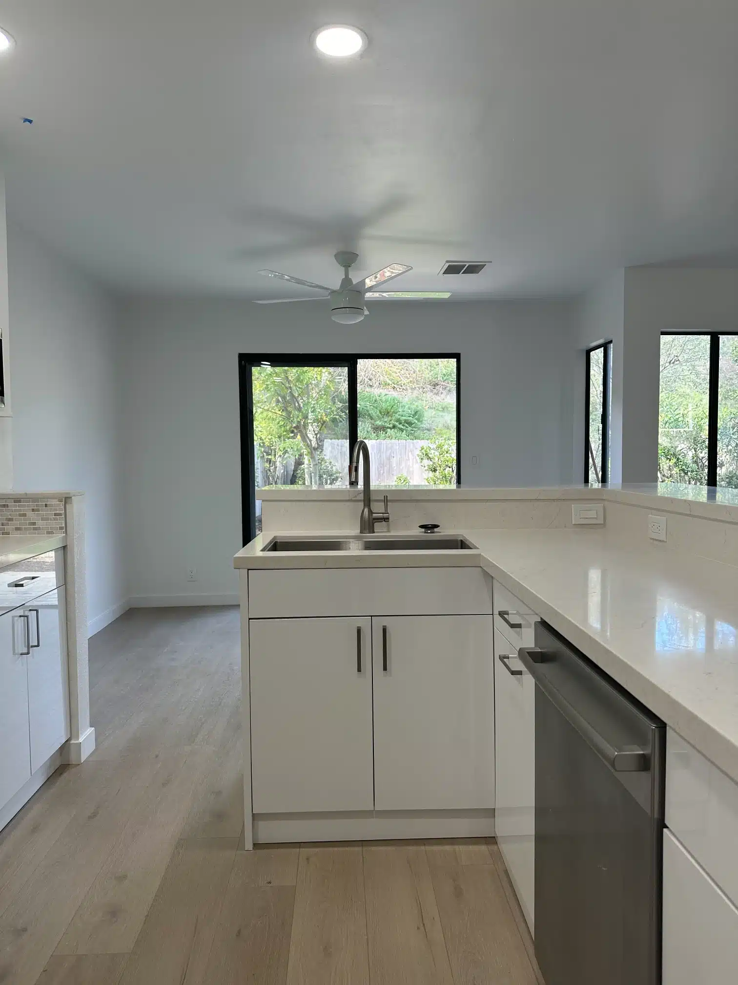 The kitchen seen from the living room across the new flooring