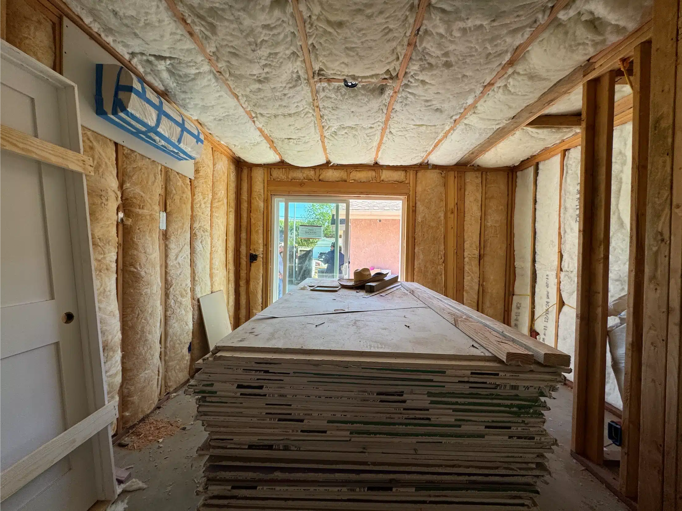 Insulated ADU interior with flooring stacked to acclimatise before installation