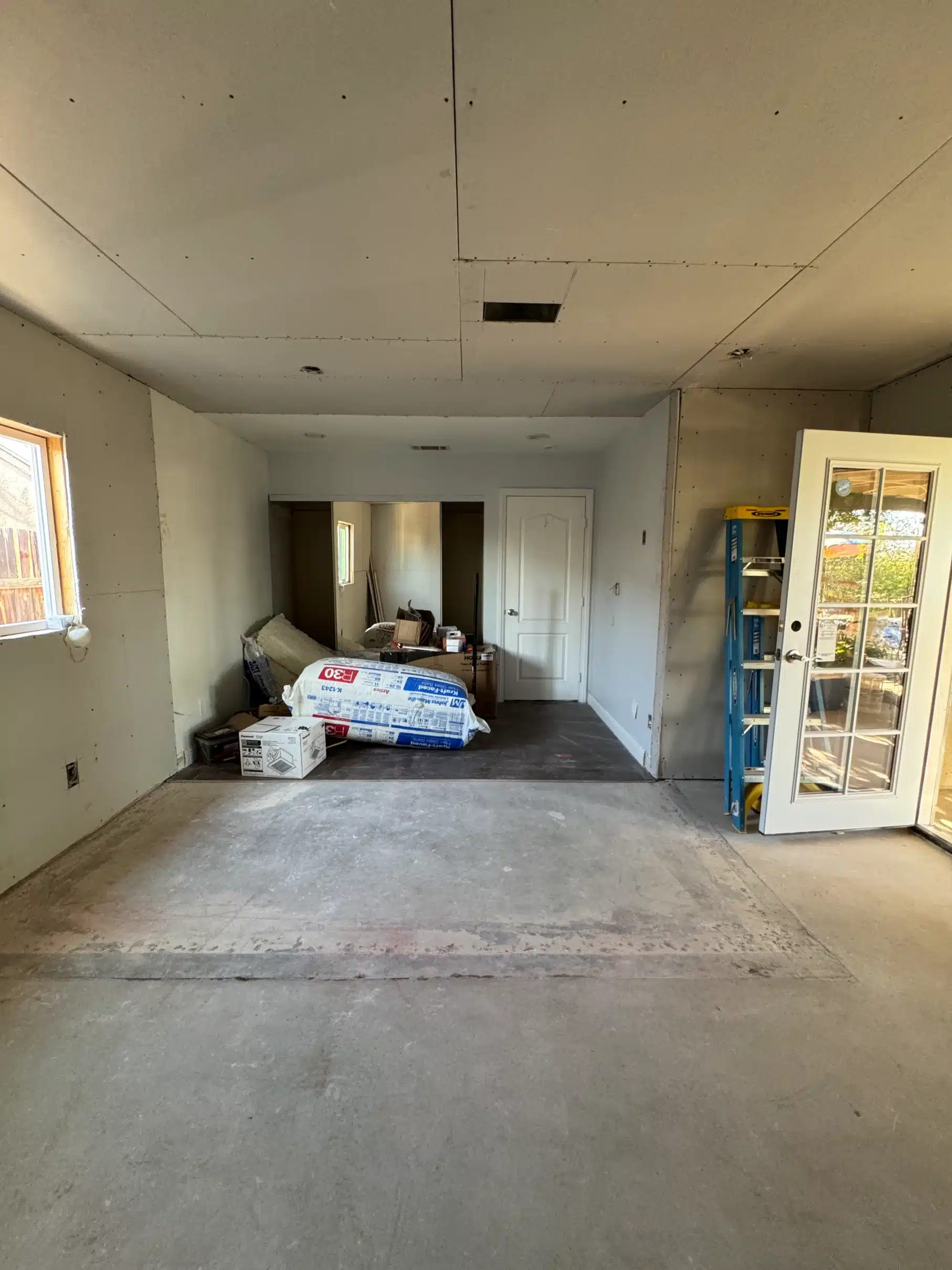 Boarded interior with door units stacked ready for installation