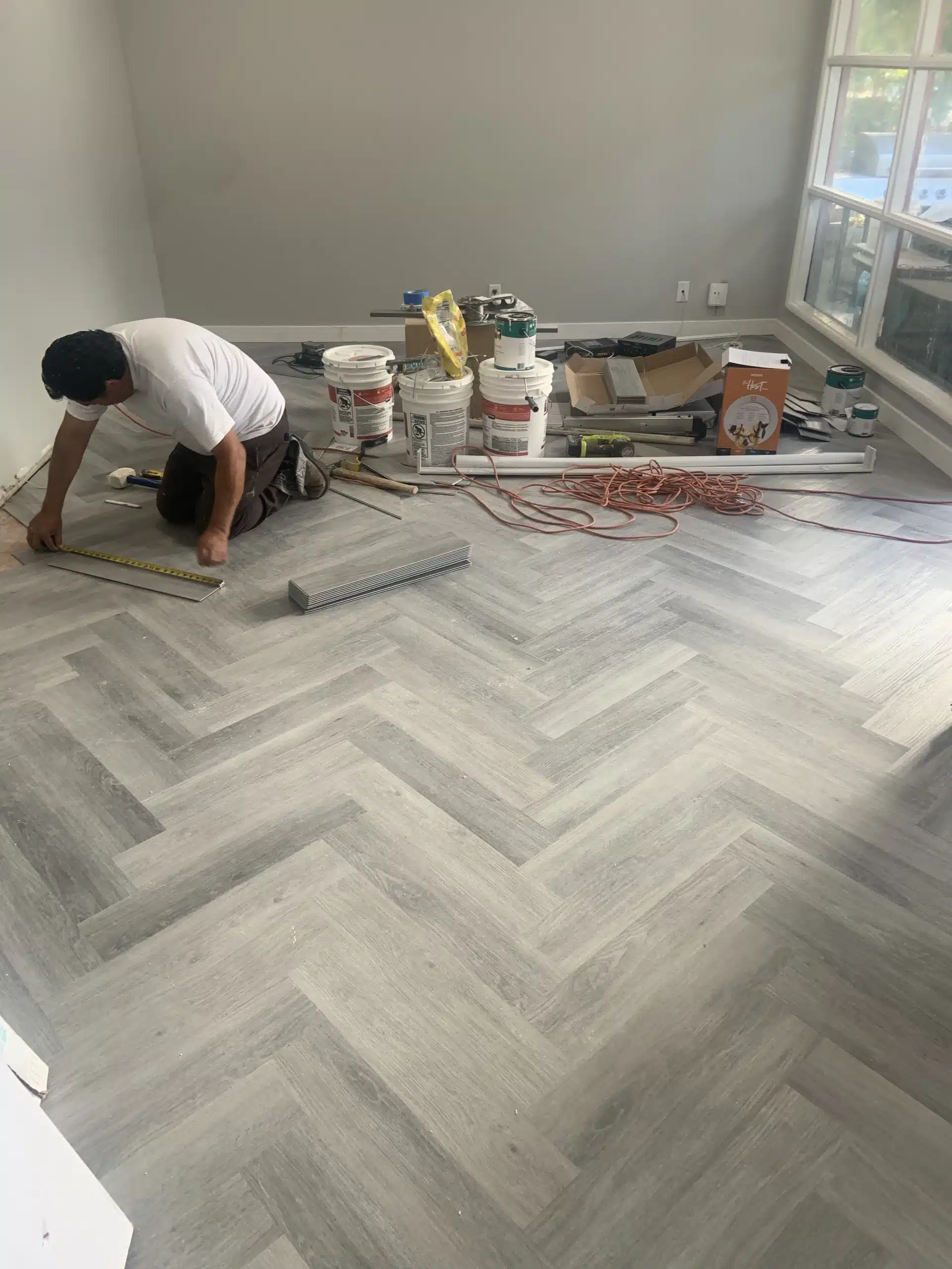 Herringbone plank being set out across the living area
