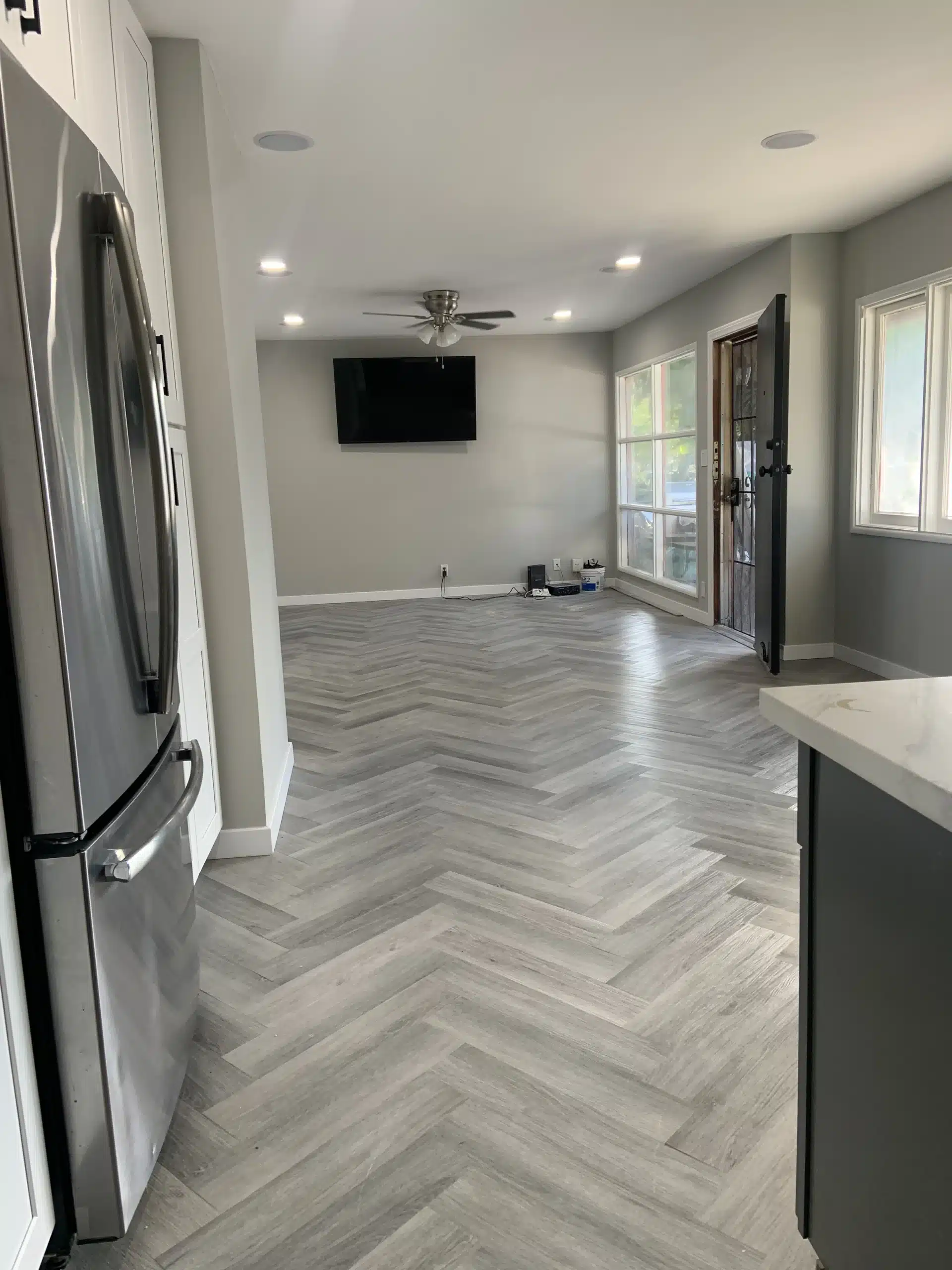Whole-home remodel in Del Mar with an open-plan kitchen and herringbone flooring