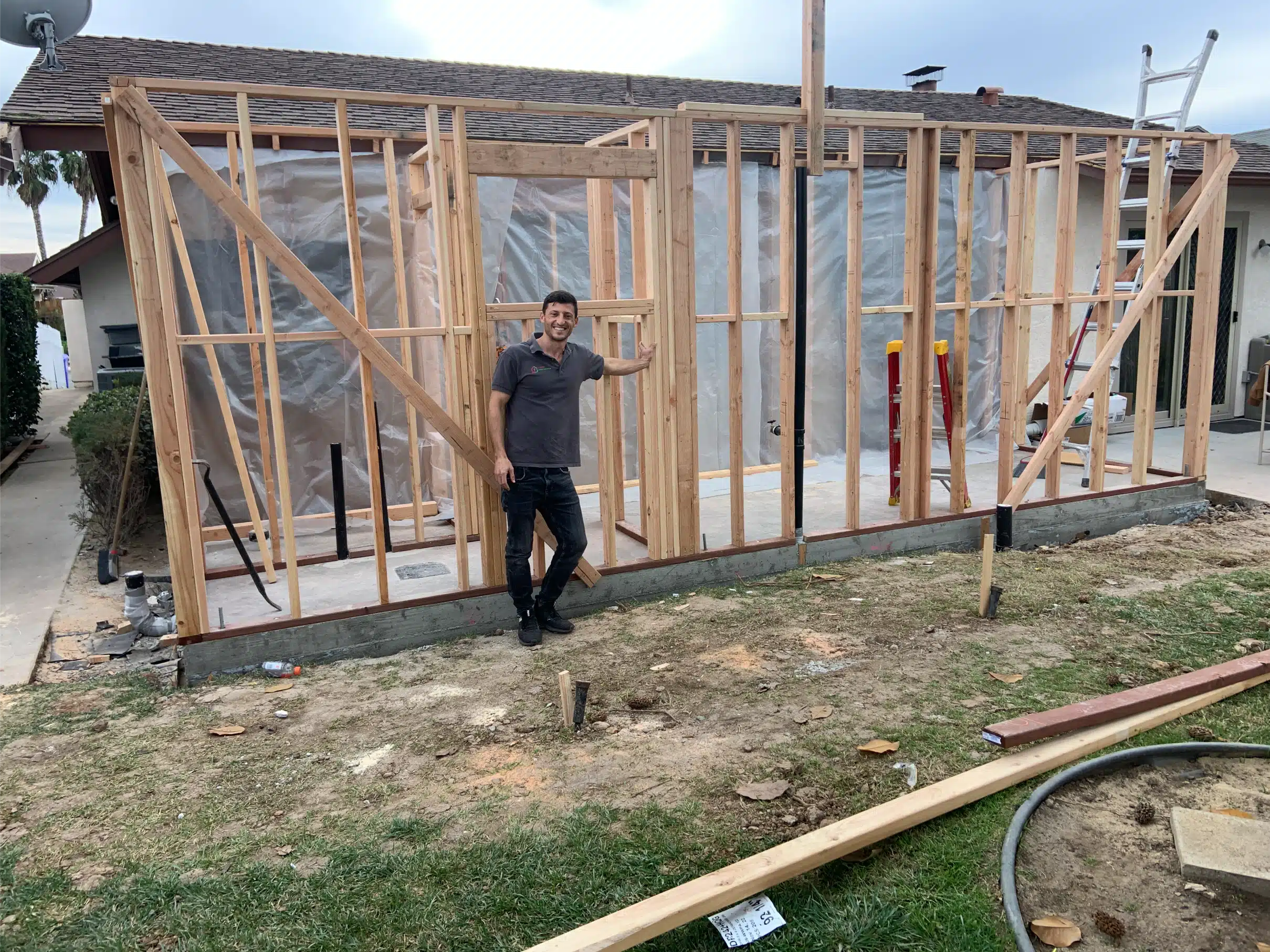 New stud walls framed on the fresh slab during the San Diego room addition