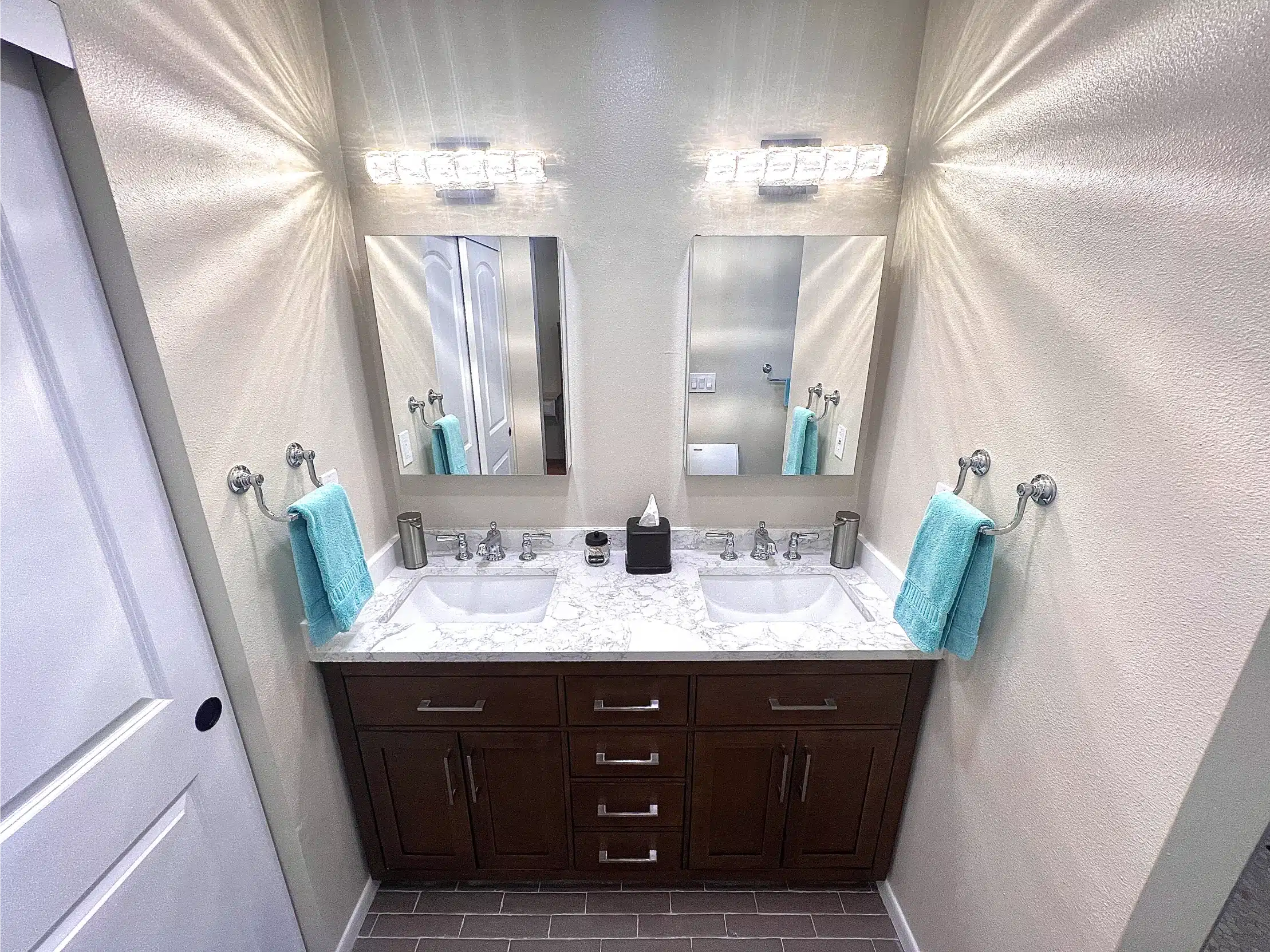 The double vanity and twin mirrors seen from the doorway