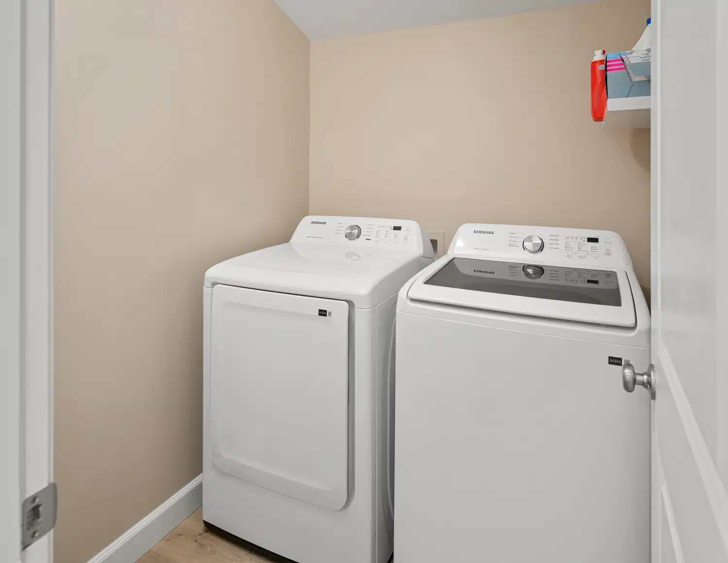 Laundry room with side-by-side washer and dryer and fresh paint