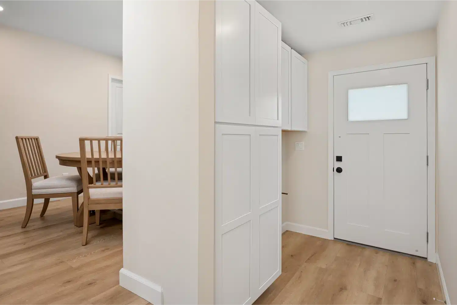 Hallway with new built-in storage cabinetry and a glazed exterior door
